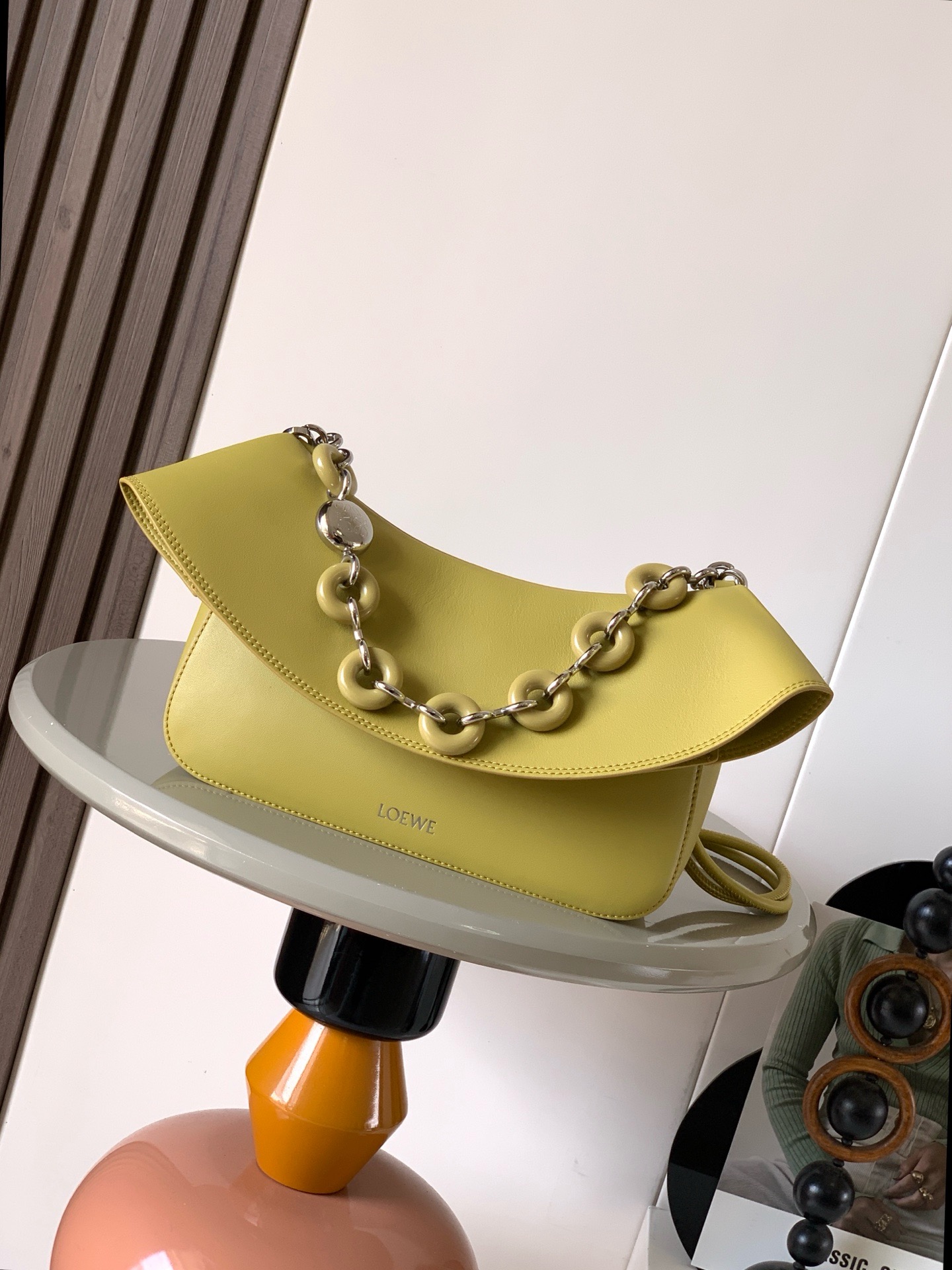 NO:895360,Medium Smooth Cow Leather Ola Handbag Ola is a soft, lightweight, flexible and versatile summer handbag with a curved body, a smooth-line flap and a striking donut chain. This medium version is made of smooth cow leather * Detachable cow leather tubular shoulder strap Detachable donut chain * Flap closure * One inner pocket L0EWE Hot stamping, engraved Anagram logo Size 26CM ~ 18CM ~ 13CM Style No. 9150  Color ginger,loewe,loewe,cowhide19860909中号光滑牛皮革 Ola 手袋Ola 是柔软轻便且灵活百搭的夏日手袋采用弧形主体、线条流畅的翻盖和醒目甜甜圈链条此中号版本采用光滑牛皮革制成*可拆卸牛皮革管状肩带可拆卸甜甜圈链条*翻盖开合*一个内袋 L0EWE 烫金,镌刻 Anagram 标志 尺寸26CM～18CM～13CM 款号9150 颜色姜黄色,罗意威,loewe,cowhide,Bag