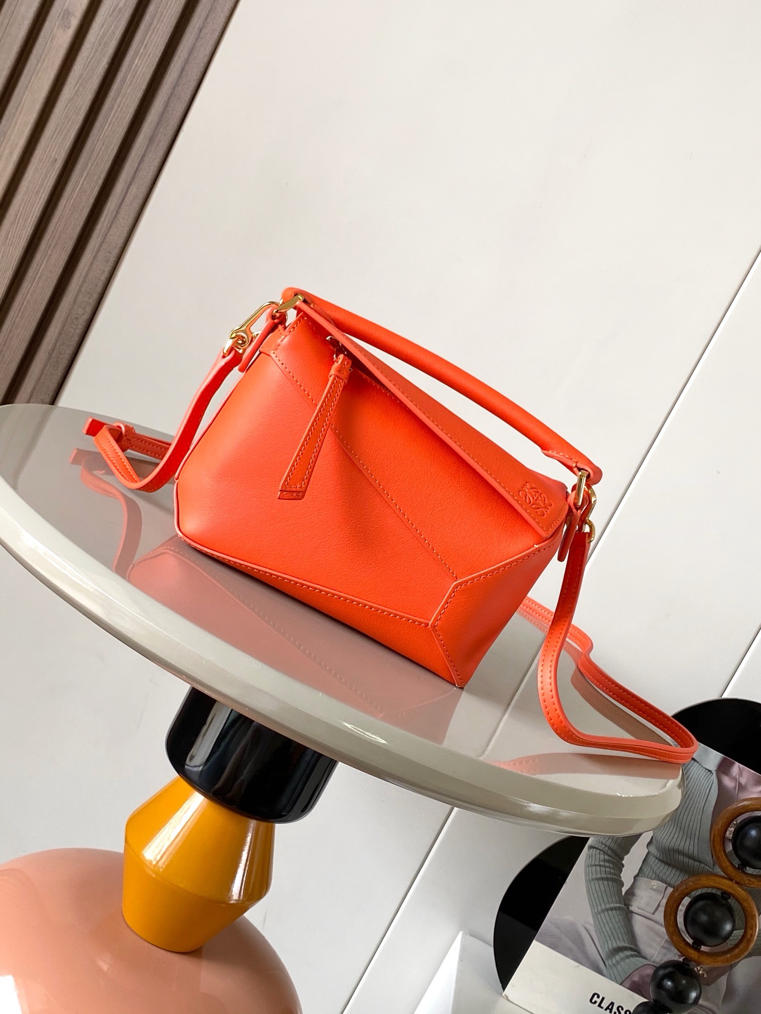 NO:942025,The popular new version of the geometric bag mini 18CM imported Napa calfskin Puzzle handbag is the creative director of Jonathan.  Anderson's first handbag for L0EWE The cuboid shape and precise cutting techniques create the unique geometric lines of the Puzzle. This mini version is crafted from classic cow leather Mini Puzzle  It can accommodate, for example, a small vertical wallet, mobile phones of most sizes (up to 6.1 inches) and sunglasses cases to be carried across the body, on the shoulder, in the hand or by the top handle. The detachable shoulder strap almost ignores the weight of the bag itself, making it practical for carrying mobile phones, small purses, lipsticks and powders when going out, without any sense of cumbersomeness, and a relaxed and happy life starts from now on (the xs and plus you are most concerned about are all OK). Size 18～12.5～8CM, style number 9310～8003  Color orange,loewe,loewe,wallets,cowhide19860909爆款新版本几何包迷你18CM原厂进口纳帕小牛皮Puzzle手袋是创意总监乔纳森．安德森为 L0EWE 推出的首款手提包长方体形状和精确的切割技术创造了 Puzzle 独特的几何线条.这个迷你版本采用经典牛皮革制成迷你 Puzzle 可以容纳例如一只小号垂直钱包、大多数尺寸的手机（最大6.1英寸）和太阳镜盒斜挎、肩背、手拿或顶部提手携带.可拆卸肩带包包自身重量几乎忽略,炒鸡实用,出门装手机小钱包口红粉饼,毫无累赘感,轻松愉快人生从此开启(你们最关心的xs,plus都ok哈） 尺寸18～12.5～8CM 款号9310～8003 颜色橙色,罗意威,loewe,wallets,cowhide,Bag