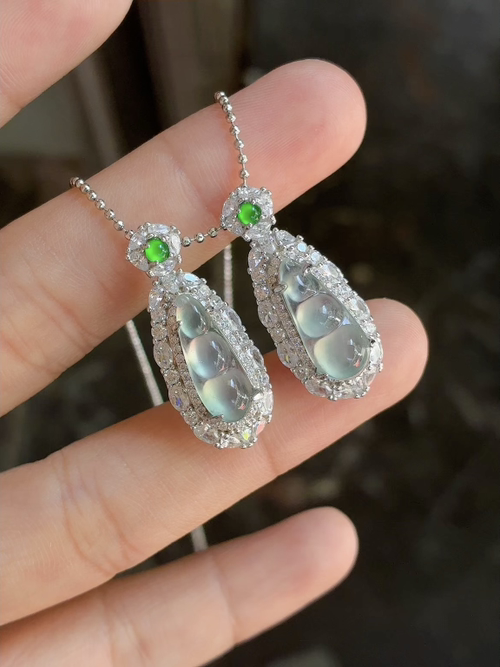 Silver-set, natural light photo: Icy translucent glow with floating green bean pendant / piece