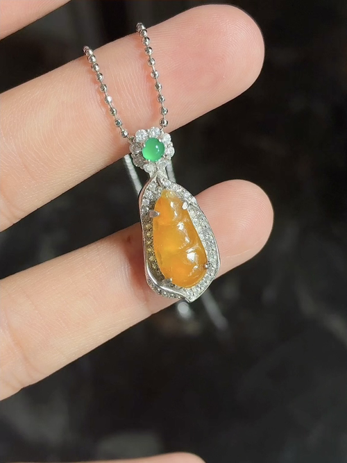 Silver-set natural light photo: translucent honey-orange bean pendant