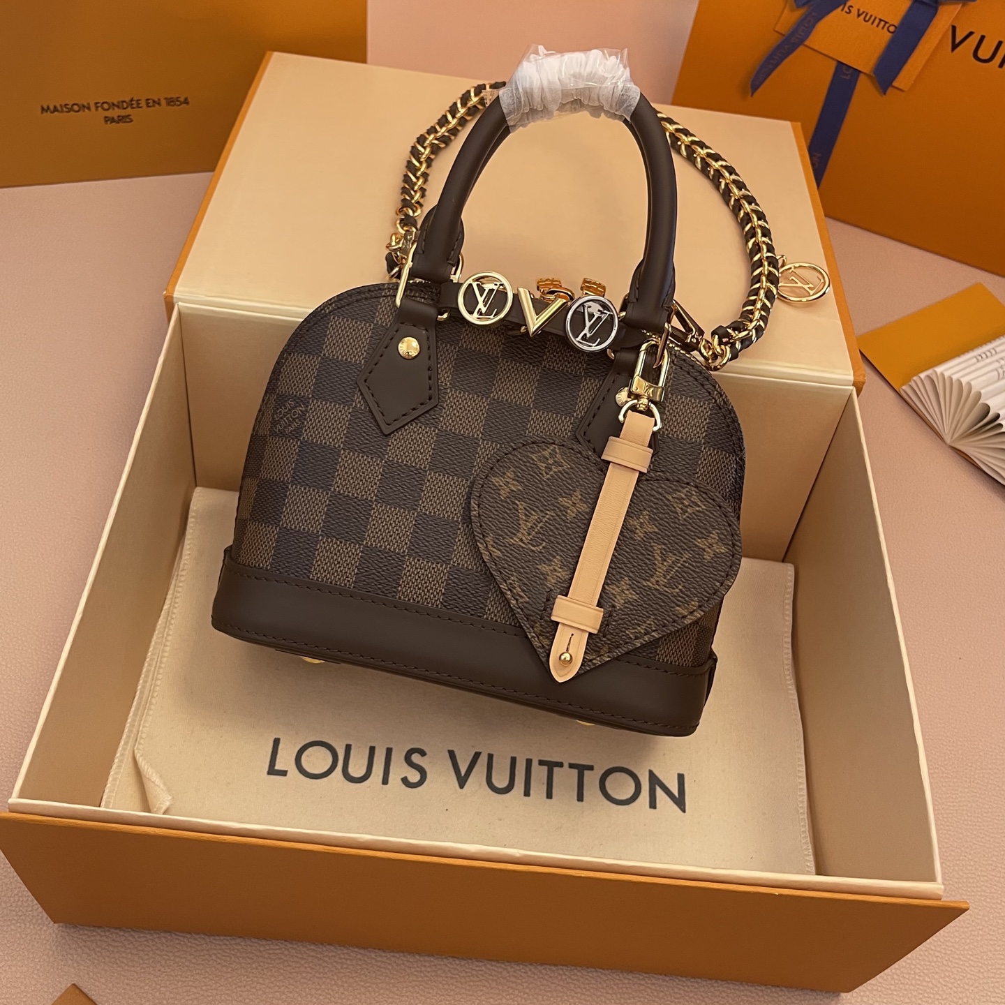 Louis Vuitton Alma Mini Handbag Damier Ebene Canvas with Heart Bag Charm 2 i1754914138815 9511 0 0