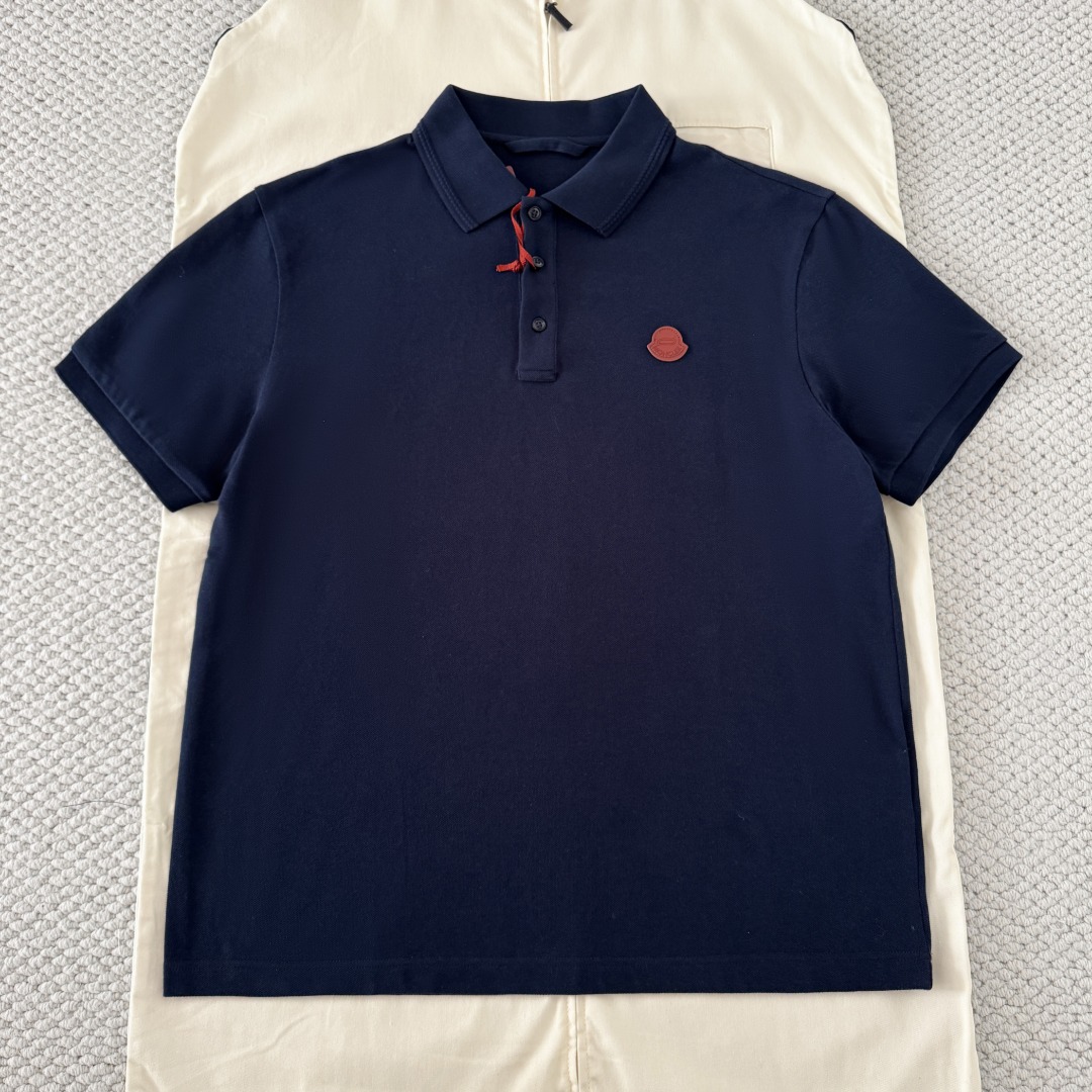 NO:823009,Original 1-1 development navy blue Monc SS26 Zhangzi short-sleeved Polo shirt 230g cotton pique plain weave  It retains the same honeycomb mesh piqué pattern as the Y version, and the edge of the neckline is tightly woven with cotton threads of the same color to replace the ordinary edging strips. It not only strengthens the neckline structure, but also avoids neck wear. At the same time, it echoes the texture of the piqué cotton fabric, making it visually more refined and tidy. After high-temperature steaming  After being steamed and set, the lapel shape remains perfect and will not curl or collapse when worn and washed for a long time. The collar always fits the neck during activities and does not become loose. Size: s/m/l/xl, Moncler, T-shirt,19860909原版1-1开发 藏青色 Monc SS26章仔短袖Polo衫 230g 棉珠地平纹布 保留了跟Y版一样蜂窝网状珠地纹,领口边缘采用同色棉线密织包边,替代普通包边条,既加固领口结构,又避免磨颈,同时与珠地棉面料纹理呼应,视觉上更精致整洁.经高温蒸汽定型之后,保持完美翻领形态,久穿、久洗不卷边、不塌陷,活动时领口始终贴合颈部,不松垮size:s/m/l/xl,蒙口-服装,Moncler,T-shirt,,Women's clothing
