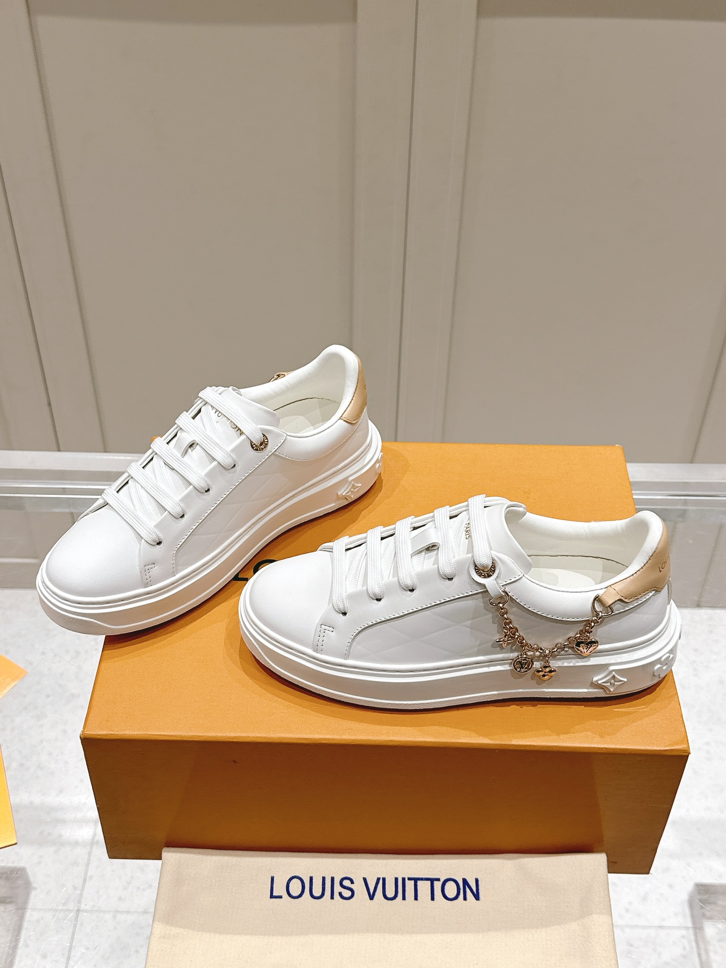 Louis Vuitton Women's White Leather Low-Top Sneakers with Charm Detail 4 i1728344964 4004 2
