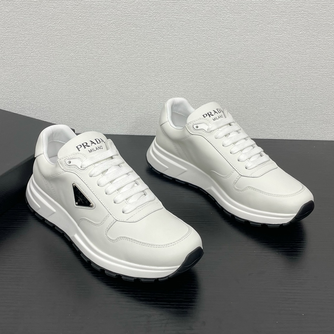 NO:664104,PRADA men's new leather sneakers. This sneaker is made of smooth calfskin upper, with a thickened rubber foam midsole and tire pattern rubber soles wrapped on the front and rear. The tongue is decorated with the brand letter logo, and the outside is decorated with the P family's classic triangular enamel badge. It has a personalized lace design. It is novel and unique, fashionable and durable, and unique. Fabric lining and cowhide foot pads make the upper foot fashionable, comfortable and breathable. Comes with a full set of original packaging!  Size 39-40-41-42-43-44 standard leather shoe size, prada, sneakers, cowhide19860909PRADA 男士新款皮革运动鞋 这款运动鞋采用光滑小牛皮鞋面制成,搭配加厚橡胶发泡中底拼接前后包裹的轮胎纹橡胶鞋底,鞋舌饰有品牌字母标识,外侧饰有P家经典三角珐琅徽章,个性系带设计,款式新颖别致,时尚耐看,别具一格.织物内里及牛皮垫脚加持,上脚时尚大方,舒适透气,配全套原包装！ 码数39-40-41-42-43-44 标准皮鞋尺码,,prada,sneakers,cowhide,Men's shoes