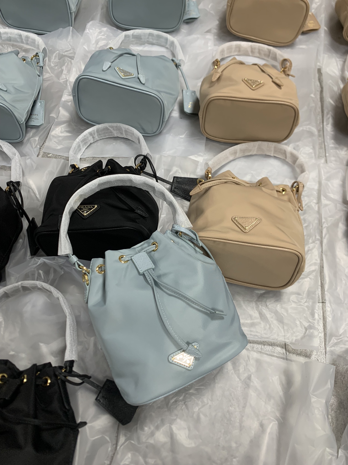 Prada small bucket bags are available in stock sizes and shipped in seconds. 19-15-10