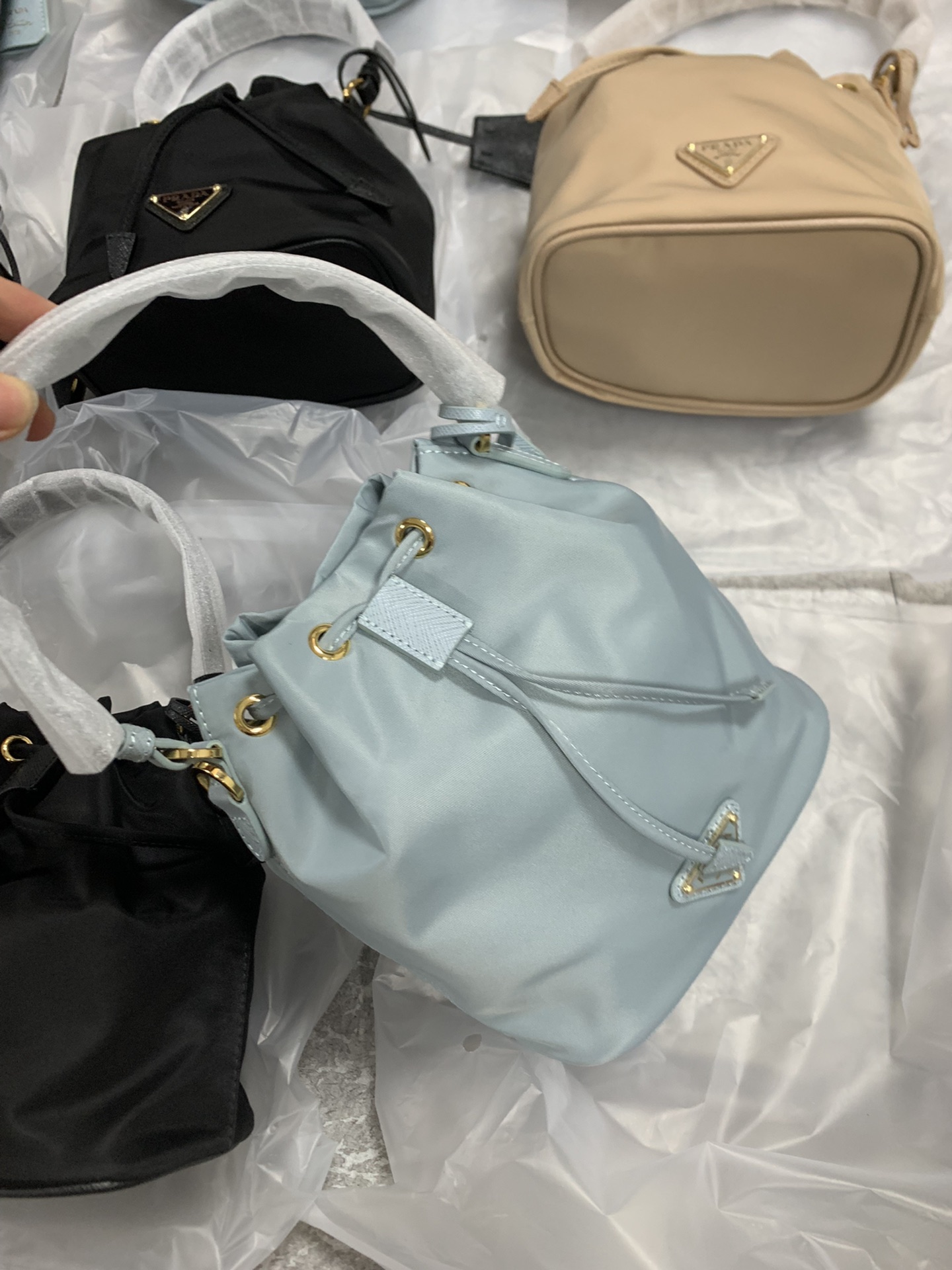Prada small bucket bags are available in stock sizes and shipped in seconds. 19-15-10