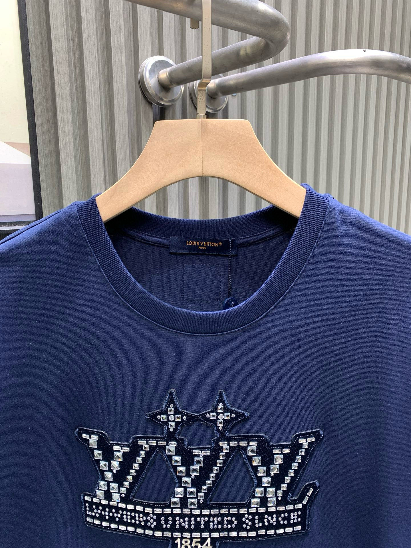 💰120🀄️   Louis Vuitton路易威登
1V 2025新款 1854钻字母棉质短袖
32支精棉平纹面料由精梳棉是经特殊工艺处理后制成其纤维更加细长且整齐
因此制成的面料在质感和耐用性上都有显著提升
纯棉材质具有优异的吸湿性  平纹面料触感柔软
穿着舒适  精梳棉的纤维结构更加紧密
因此制成的面料耐磨性更好  不易起球或变形
对花定位点缀图案  选钻是选择适合烫钻的钻石
排钻是将钻石按照设计好的图案排列在模板上
镶钻则是通过烫钻机固定在面料上
背面胶的颜色应均匀一致  且牢固度要高
结合了硅油的柔软性和弹力胶浆的高密度特性
材料具有优异的拉伸和恢复性能
在受到外力作用时能够迅速恢复原状
保持图案的完整性和清晰度