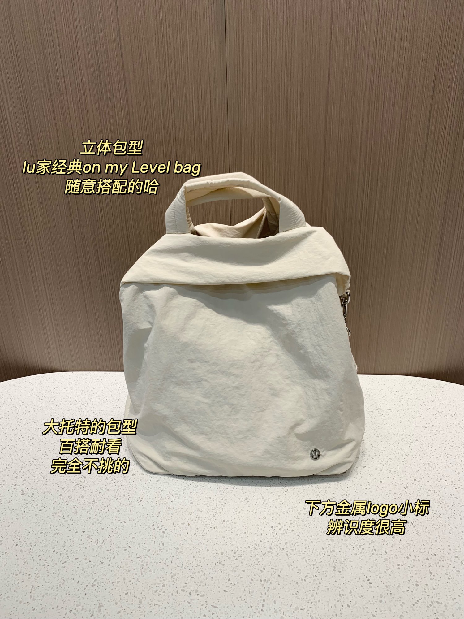 this bag is detailed with a small metallic logo accent - Bag
