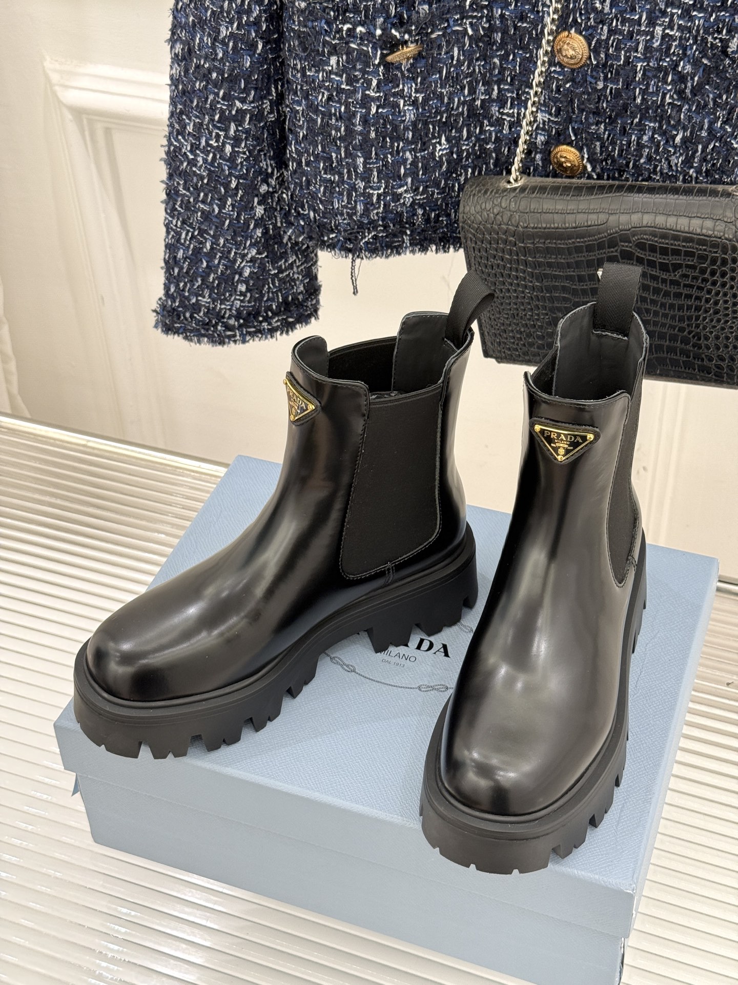 Prada/普拉达经典三角标厚底短靴当米兰的百年匠艺碰撞当代街头美学它不止是秋冬靴履的奢华范本更是跨越潮