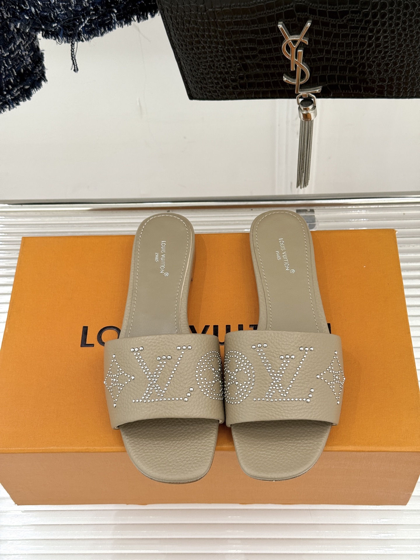 L*V驴家经典铆钉标识一字带拖鞋以极简带面勾勒足间线条金属铆钉缀以经典 Monogram 标识硬朗锋芒碰