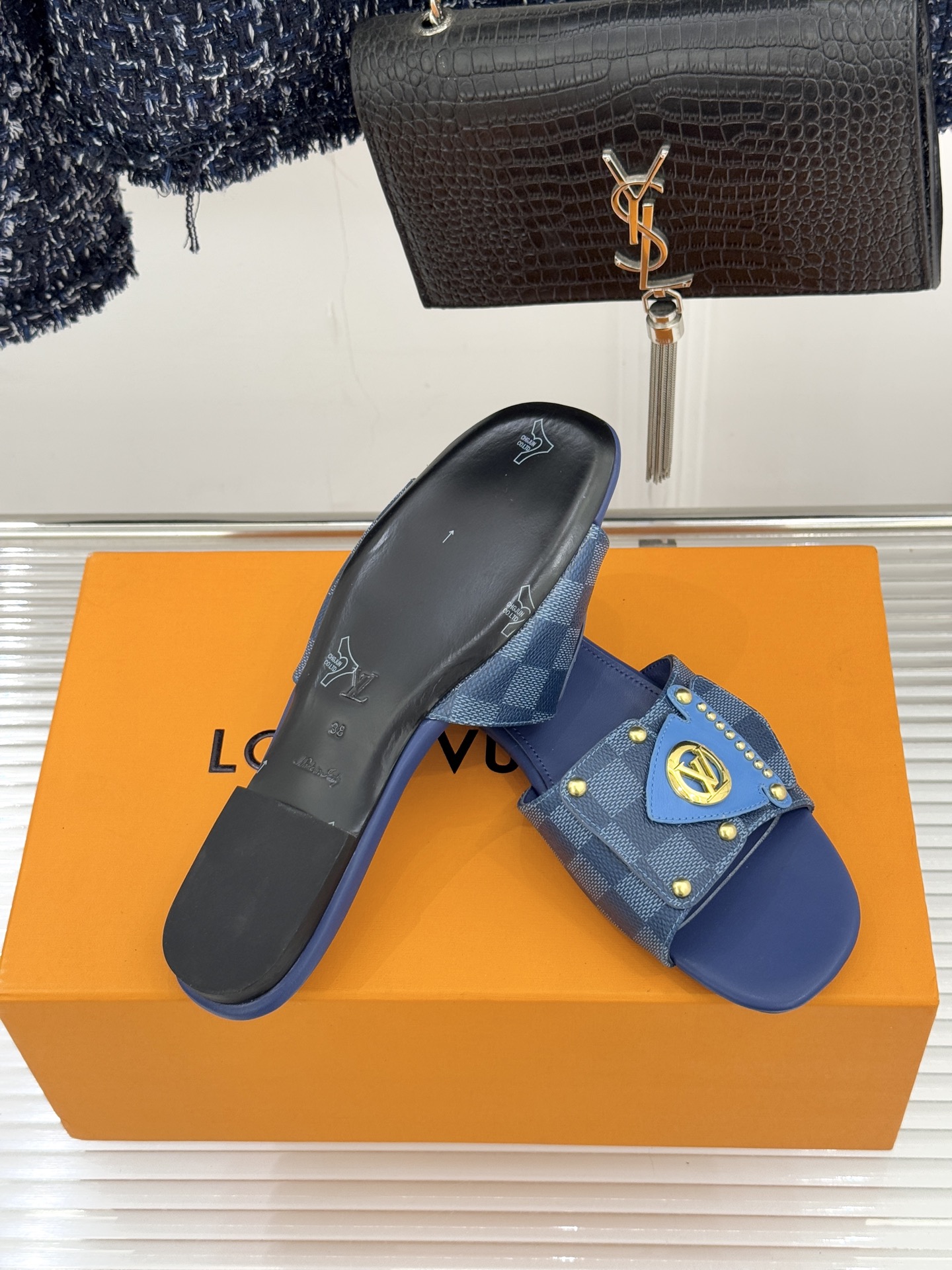 L*V驴家经典老花金属扣平底拖鞋以标志性老花皮革勾勒优雅轮廓意大利匠心工艺凝萃百年奢韵。亮眼金色金属扣镌