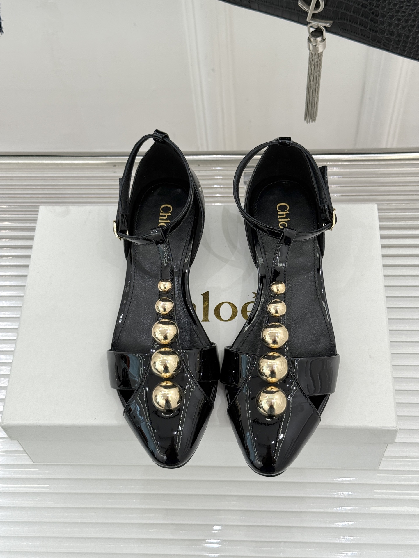 Chloé/蔻依26WF新品Cleia漆皮铆钉镂空T带凉鞋以法式优雅诠释轻奢美学。高光漆皮质感搭配利落尖