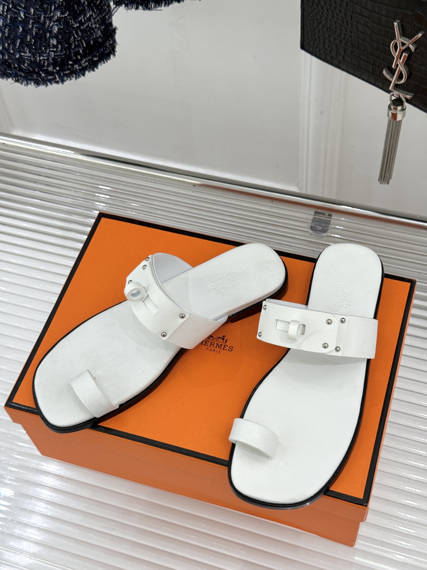 Hermès/爱马仕经典Kelly夹脚拖鞋以经典Kelly金属扣重塑夹脚拖鞋格调。甄选细腻小牛皮 触感柔