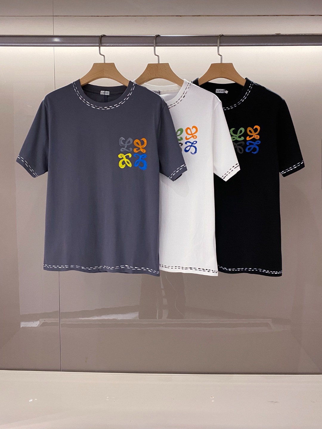 NO:136374,[New Product] 2025 Spring and Summer New Lo*we Anagram Colorful Graffiti Logo Men's Pure Cotton Short-Sleeved T-shirt. The latest fashion temperament extends the charm infinitely to the unique charm of fashion. Worn-spun flat-woven cotton is designed using imported machine textile design. The unique and innovative design is characterized by the more delicate cotton surface woven without any scattered flaws, breathable and comfortable, and soft and delicate. The Anagram Logo Colorful Graffiti Logo on the chest has become the finishing touch of the entire T-shirt. These graffiti are not casually painted, but are carefully conceived and laid out by the designer. Every stroke and every stroke contains a unique artistic atmosphere!  The graffiti is bright in color and the patterns are varied, which not only shows the vitality and ostentatiousness of young people, but also is a work of art that is unforgettable!  The dotted print decoration of the neckline, cuffs and hem is also a highlight of the design. These dotted prints are presented in a simple but fashionable way, complementing the graffiti logo, and jointly creating a visual sense of layering and dynamic!  The basic straight round neck style is not only in line with the public aesthetics, but also easy to match with various clothing. It is recommended for the same style as men and women!  Color black white gray Size S M L XL XXL Size data S S shoulder width 46cm-bust 104cm-length 66cm M Shoulder width 49cm-bust 110cm-length 68cm L Shoulder width 52cm-bust 116cm-length 70cm XL Shoulder width 55cm-bust 121cm-length 72cm XXL Shoulder width 57cm-bust 126cm-length 74cm, T-shirt,tees,t-shirt,alexander wang19860909【新品】2025春夏新款Lo*we Anagram 彩色涂鸦标识男士纯棉短袖T恤.最新的时尚气质将魅力无限延伸时装的别样韵味.精纺平织棉,采用进口机纺织造设计而成.独具创新的设计,特点在于织造棉面更为细腻无任何零散瑕疵,着身透气舒适,手感柔软细腻.胸前Anagram Logo彩色涂鸦标识成为了整件T恤的点睛之笔,这些涂鸦并非随意挥洒,而是经过设计师精心构思与布局,每一笔、每一划都蕴含着独特的艺术气息！涂鸦色彩鲜艳,图案多变,既展现了年轻人的活力与张扬,又不失为一件艺术品,让人过目难忘！领口、袖口以及下摆的虚线印花装饰也是设计中的一大亮点,这些虚线印花以简洁而不失时尚感的方式呈现,与涂鸦标识相得益彰,共同营造出一种视觉上的层次感与动感！基础直筒圆领版型,既符合大众审美,又易于搭配各种服饰,男女同款推荐！ 颜色黑色 白色 灰色 尺码S M L XL XXL 尺码数据 S码肩宽46cm-胸围104cm-衣长66cm M码肩宽49cm-胸围110cm-衣长68cm L码肩宽52cm-胸围116cm-衣长70cm XL码肩宽55cm-胸围121cm-衣长72cm XXL码肩宽57cm-胸围126cm-衣长74cm,,T-shirt,tees，t-shirt,alexander wang,Men's clothing