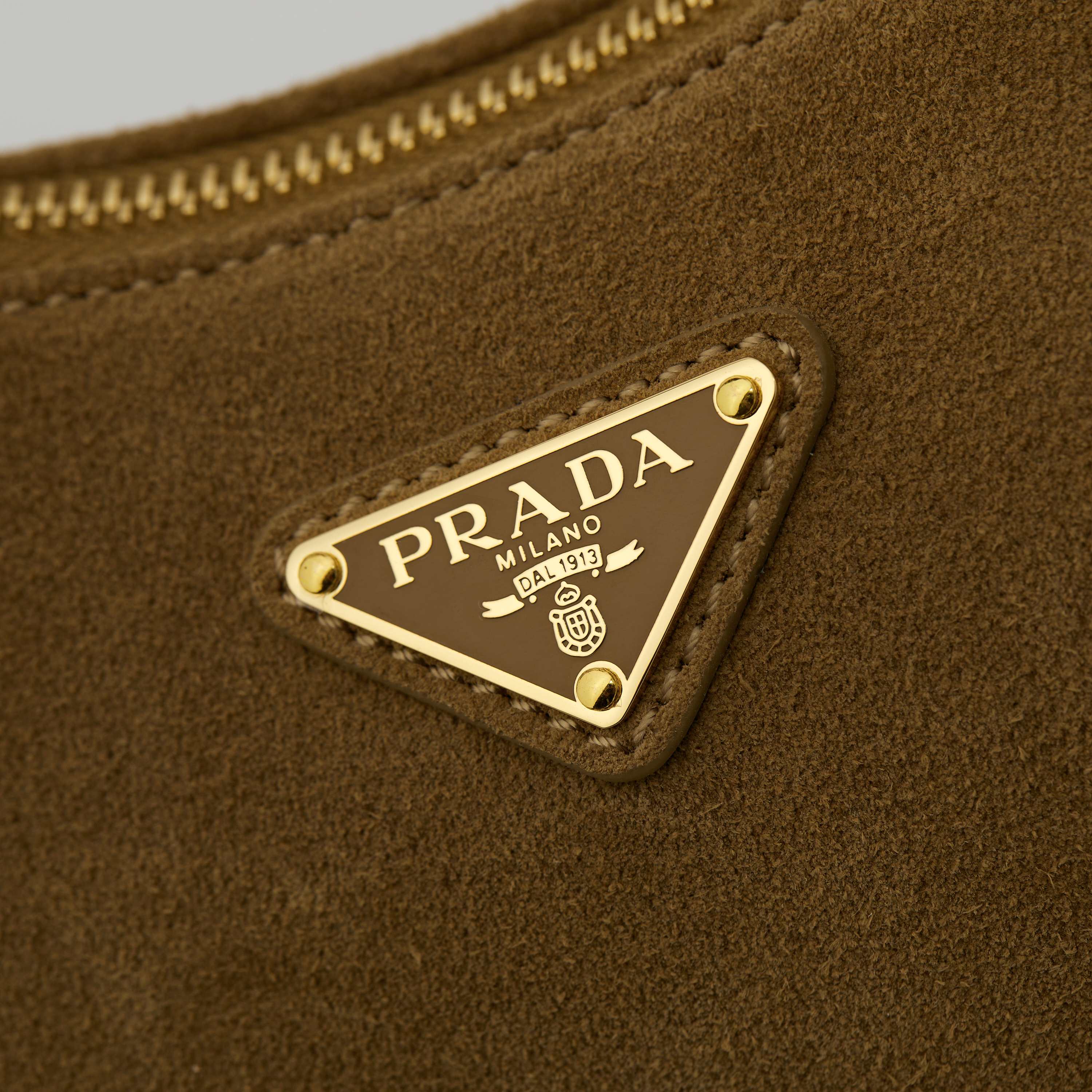 p710。 【特级原厂】🎉🎉🎉1BC229/肉桂色/磨砂皮🔥🔥🔥Prada Etude小号绒面皮革 
2025秋冬系列广告大片中的全新Prada Aim&eacute;e手袋造型精致优雅，设计灵感源自1990年代的极简主义风格。采用柔软的绒面牛皮革打造，让人不由得想将其拿在手上，亦可轻松单肩背。&middot;搭配可调节提手。最小垂长38厘米-最大垂长28厘米
●可拆卸钥匙扣
&middot;金属五金配件
&middot;正面涂珐琅三角形金属徽标
&middot;拉链开合
&middot;内里配2个内袋，包括1个拉链袋
宽:31cm&times;高:18cm&times;长:10cm