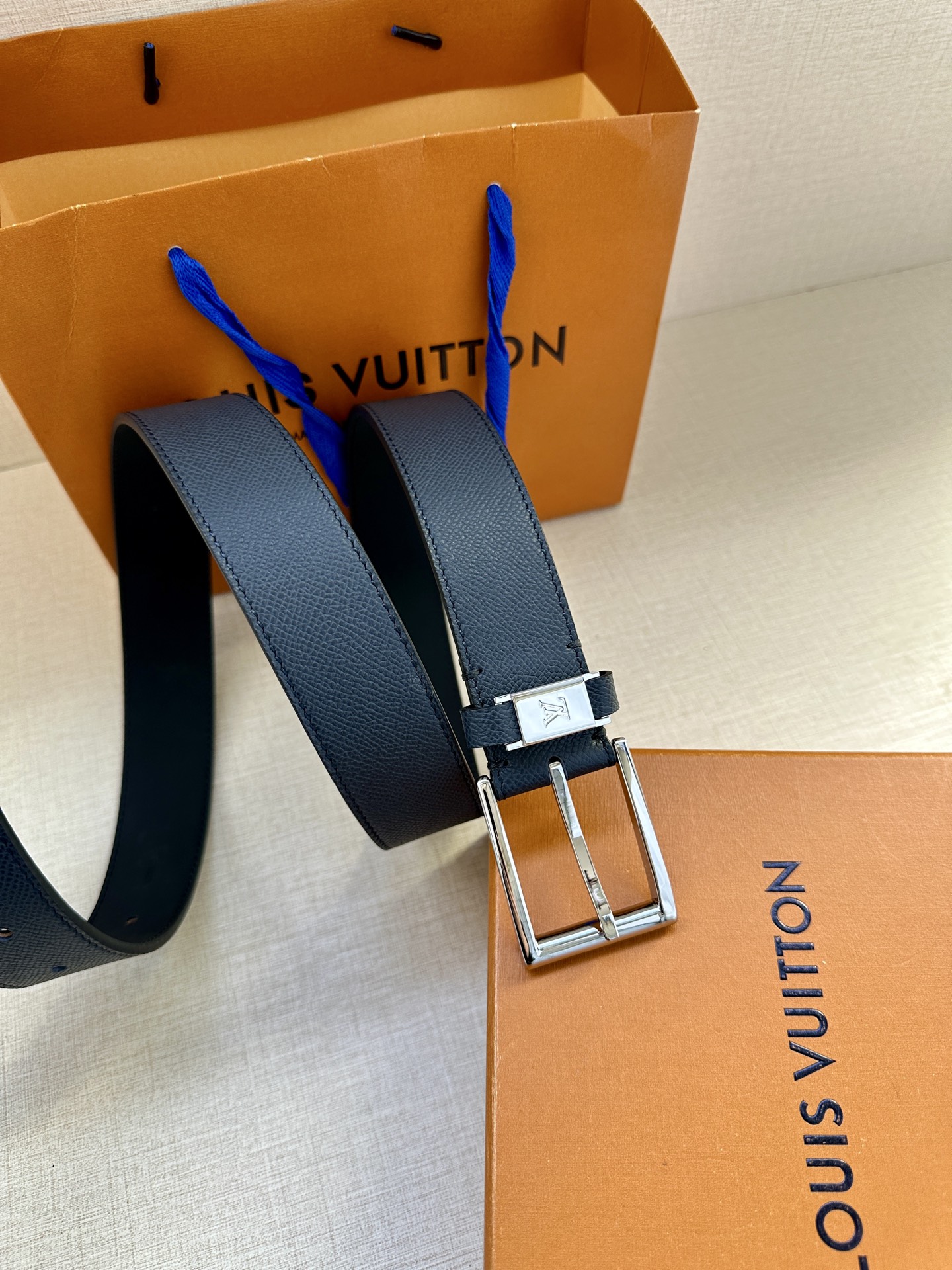  本款 LV City Pin 腰带以深邃 Taïga 皮革构筑纤细轮廓，传递简约美学。金属塑造 LV 