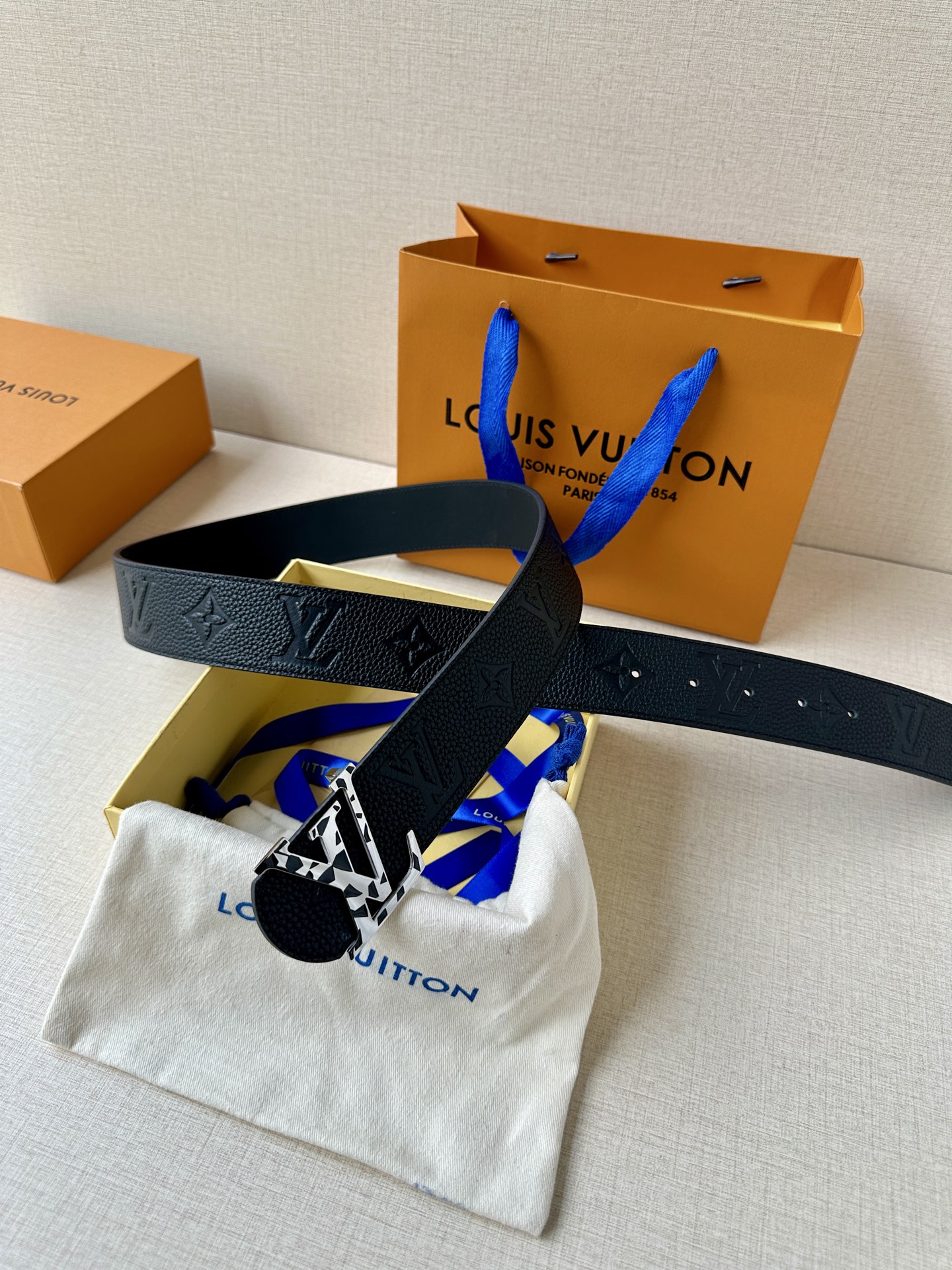  本款 Damier LV 40 毫米双面腰带做工精良，风格经典。深色牛皮革皮带与 LV 字母搭扣优雅相