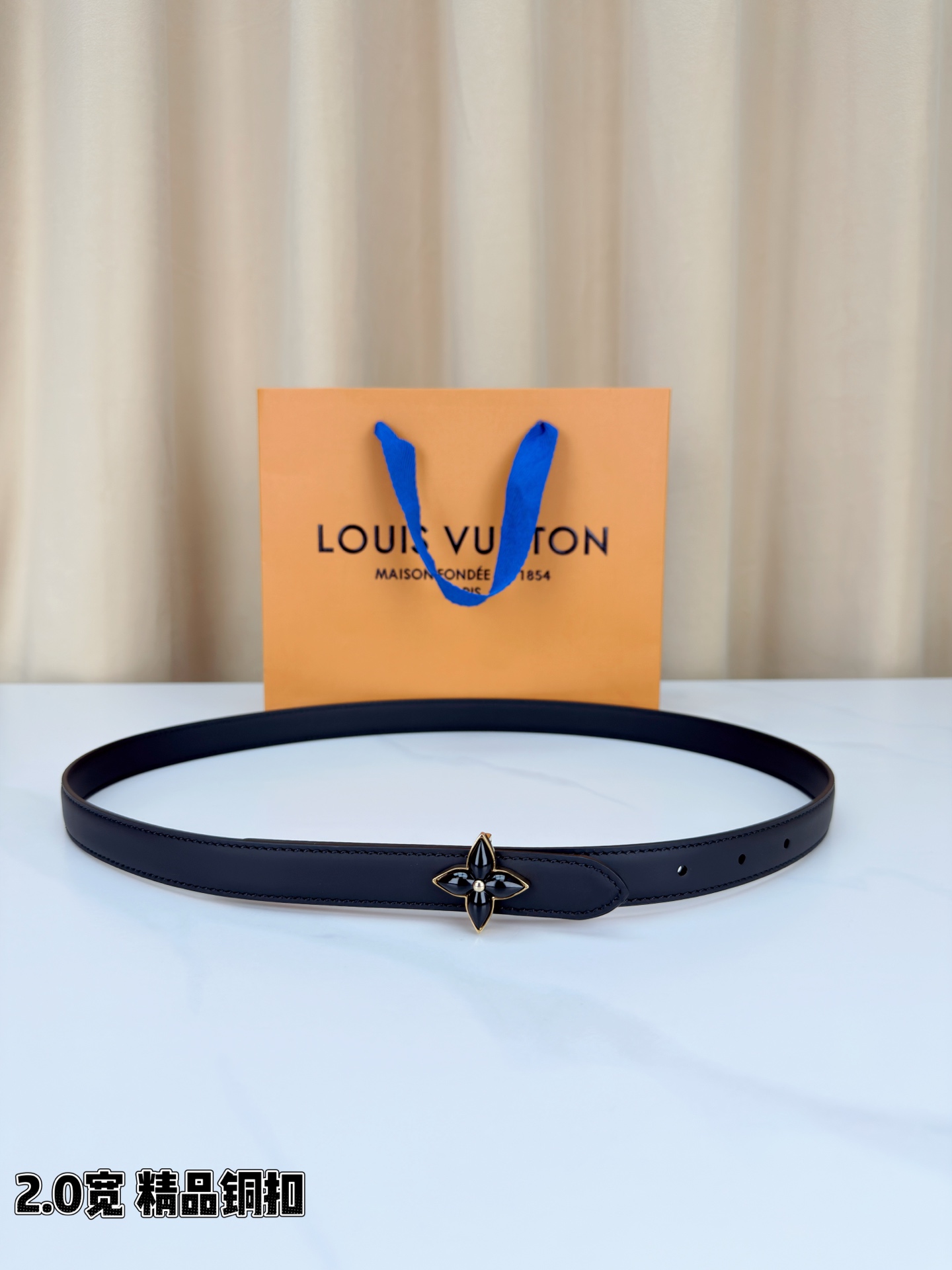路易威登2.0宽细腰带，四叶花铜扣缀以金色包边，中心金属珠灵动点睛。红黑双色可选，皮革细腻柔软，同色缝线