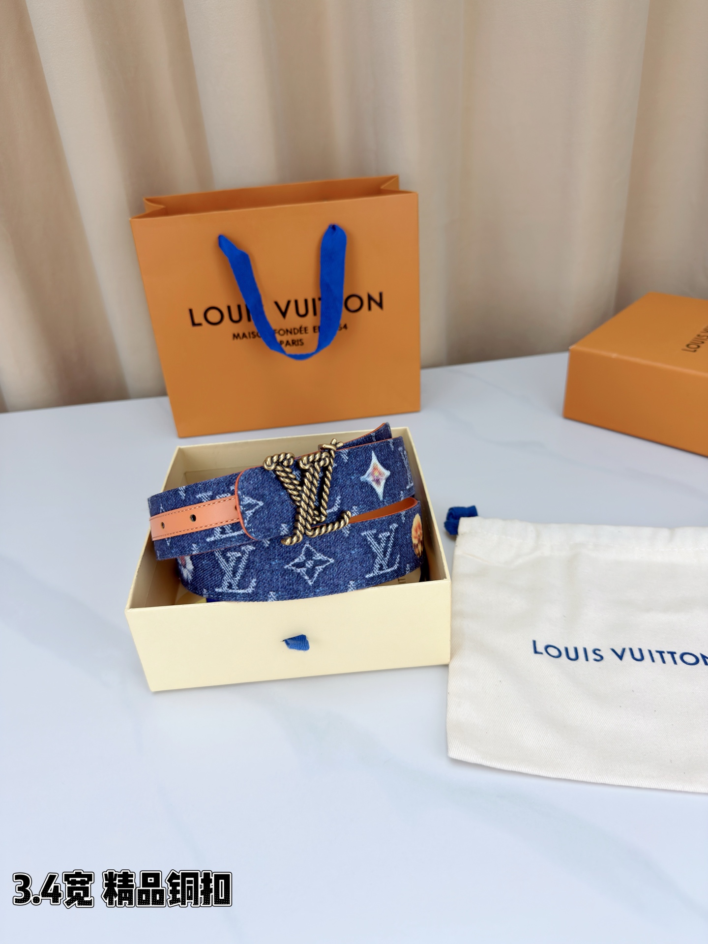路易威登3.4宽精品铜扣腰带，深蓝牛仔邂逅暖橙皮革，双面风情随心切换。金色扭绳LV扣熠熠生辉，银链V形扣