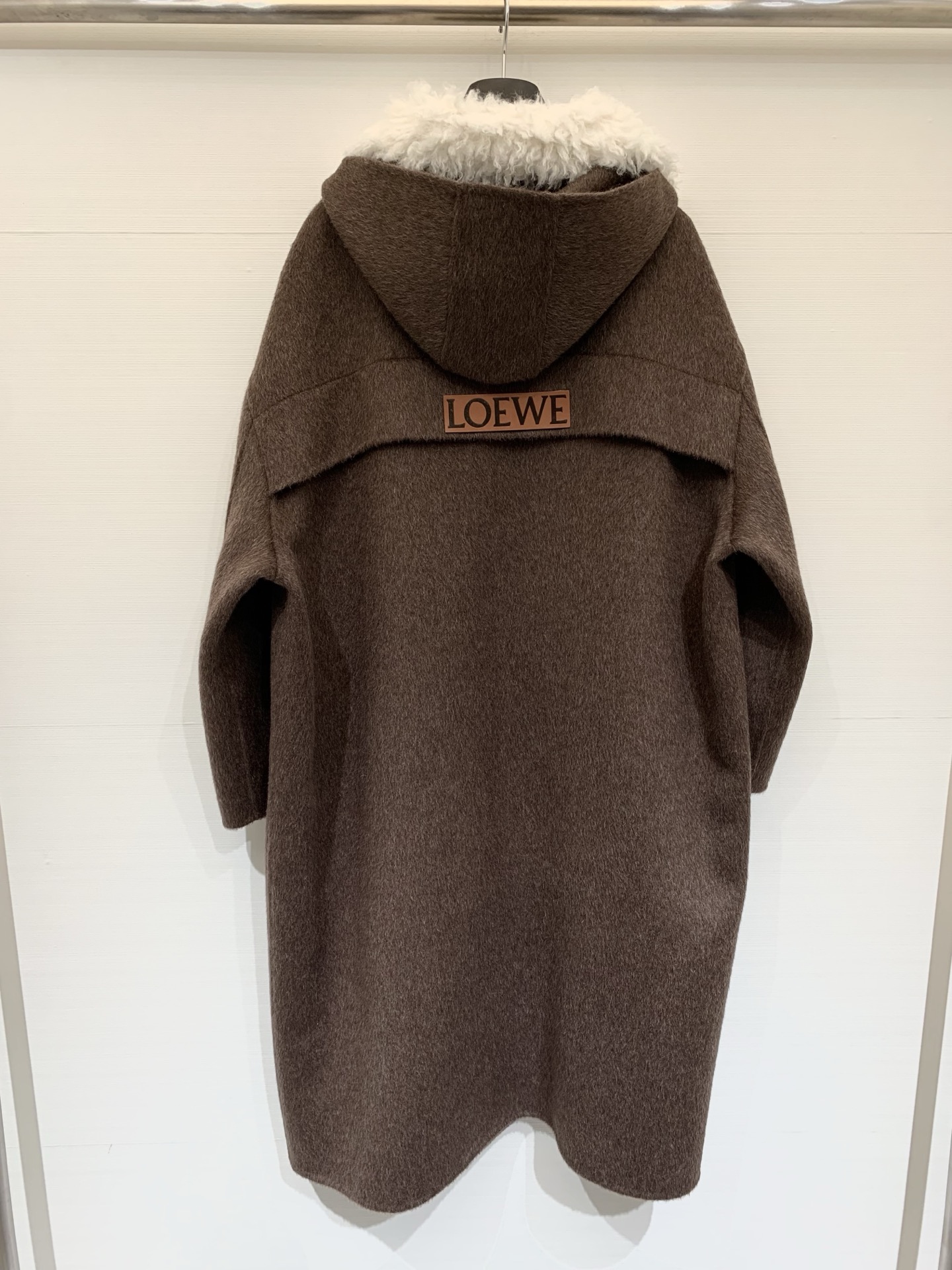 Loewe 25秋冬新款 毛绒拼接宽松长款连帽大衣，采用羊驼毛和羊毛混纺面料，质感丝滑柔软舒适，领口、拉