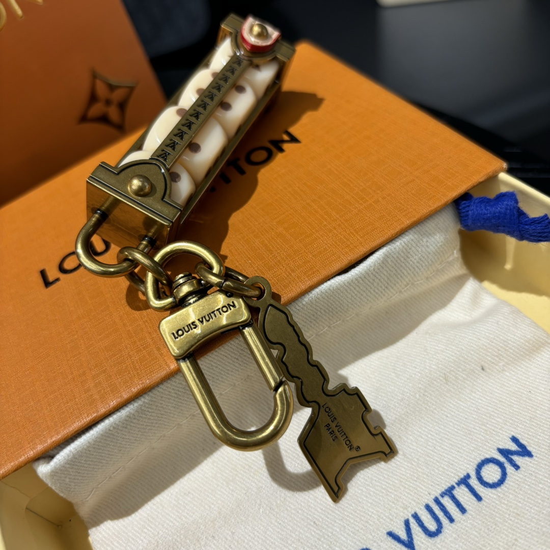 A hand holding Lovers Dice Leather Keychain