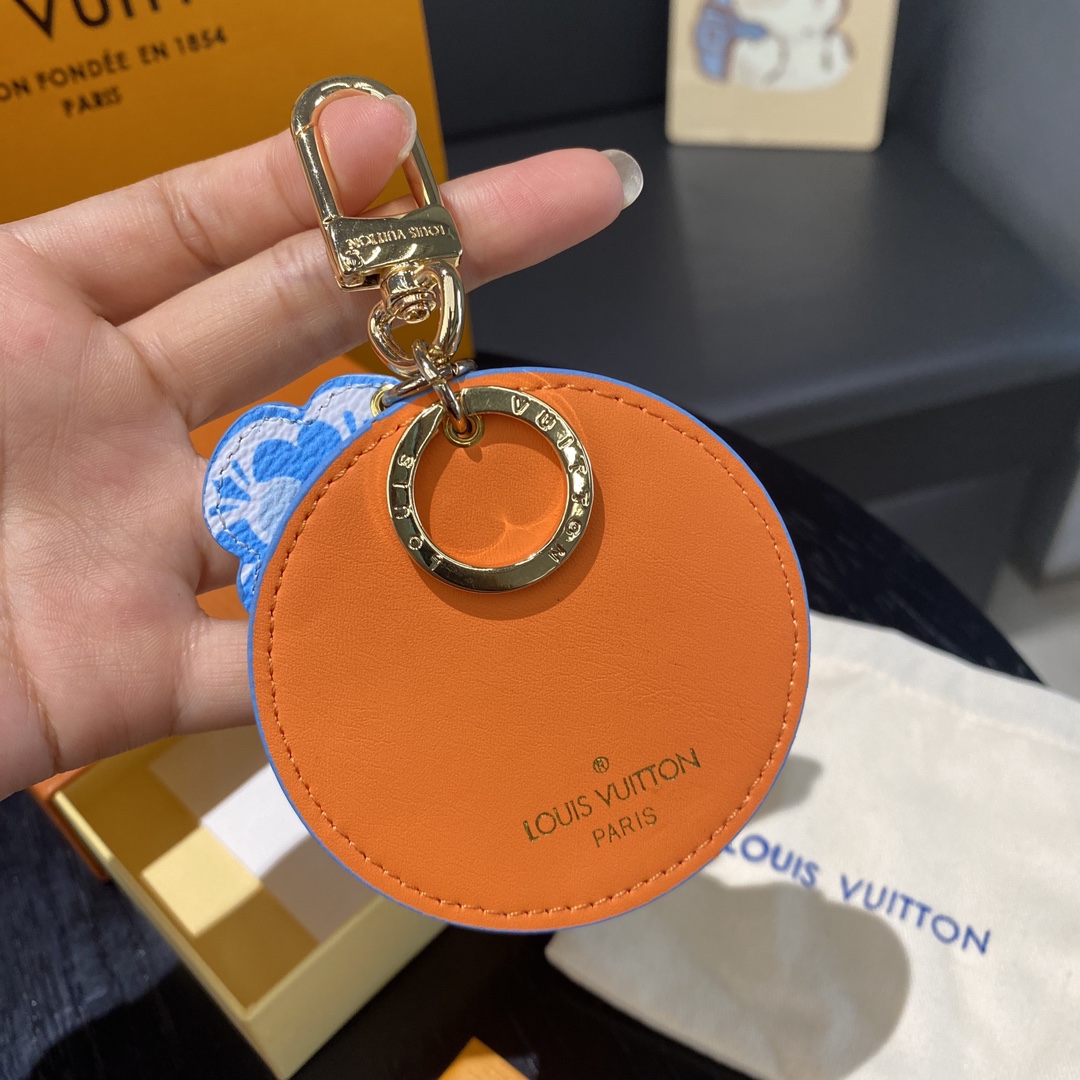Watercolor print leather keychain attached to a bag