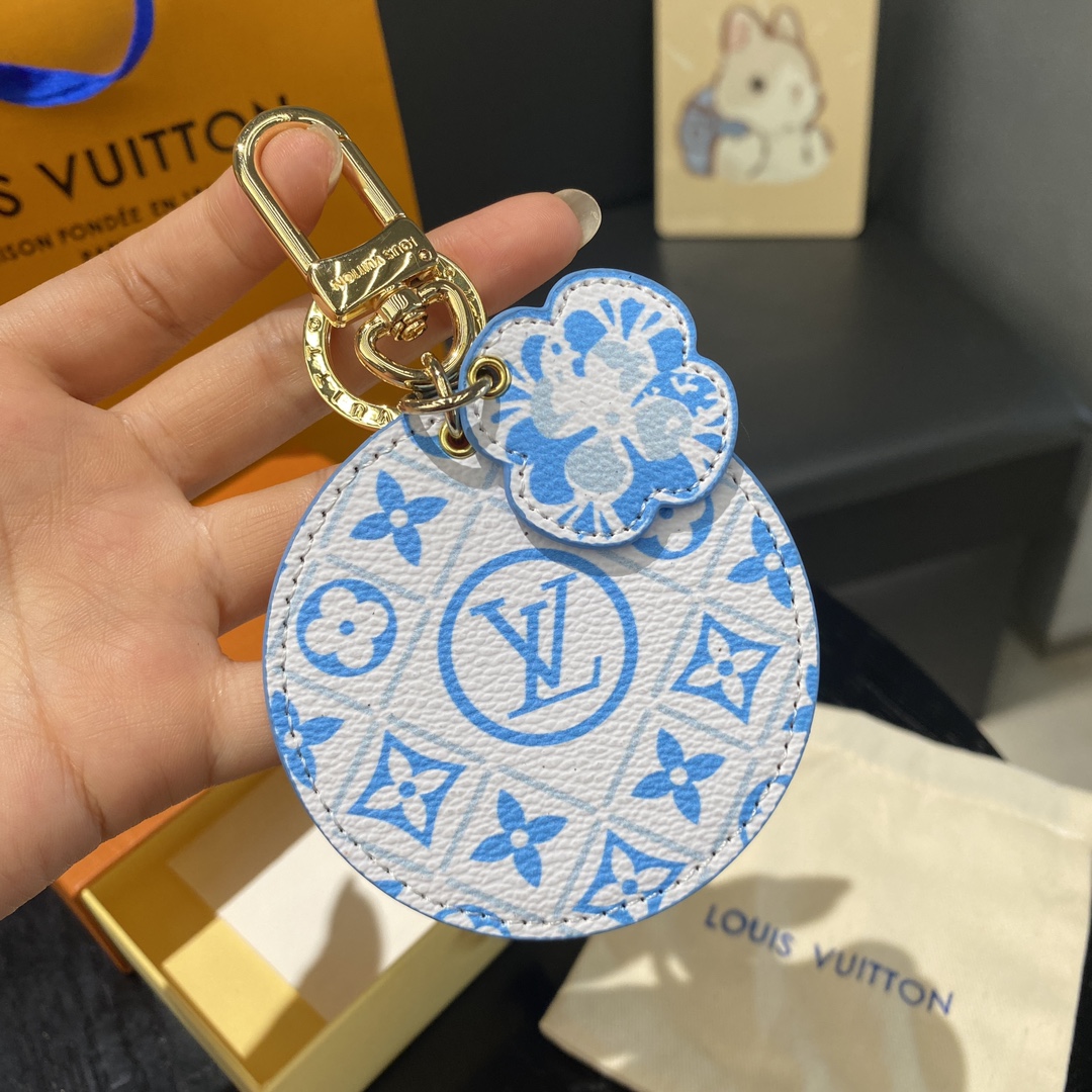 Watercolor print leather keychain held in hand