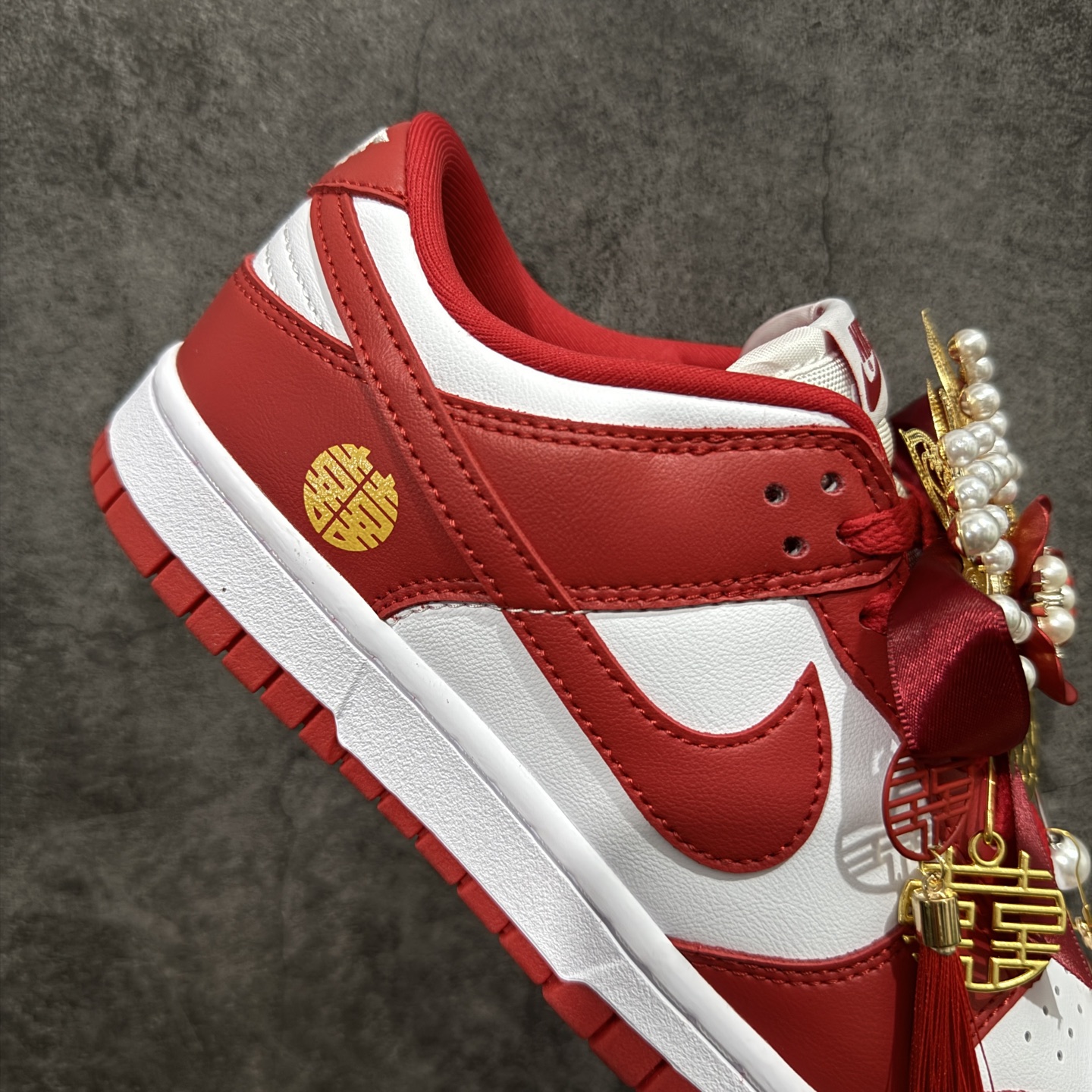 图片[7]-【纯原礼盒版本】NK Dunk Low 低帮婚鞋 锦绣良缘 货号：CU1727-100 该定制版球鞋选用原鞋款为Dunk SB系列球鞋，灵感来自中式婚庆，保留原鞋灰白红基调的基础上，叠加红色丝绒鞋带、增加整体的质感。配饰有双喜金属小挂件，再次呼应主题，呈现出中式婚礼的喜庆、庄重、雅致！鞋面金属挂件及鞋头喜字均可拆卸，同时满足婚庆和日常穿搭需求。本产品所有图片均为实物拍摄，受环境、设备影响会存在微小的色彩差异。定制球鞋均为纯手工定制，满足日常穿戴需求，穿着过程尽量避免剧烈运动和锐物划伤、避免使用高浓度的有机溶剂进行擦洗。 尺码：35.5 36 36.5 37.5 38 38.5 39 40 40.5 41 42 42.5 43 44 44.5 45 46-选品中心