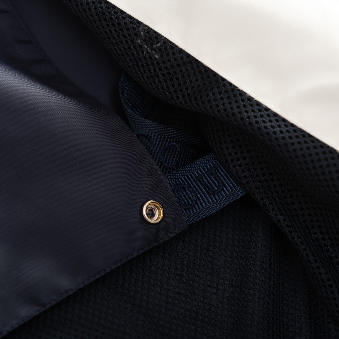 。GUCCI饰贴饰斜纹尼龙夹克面料选择：选用100%锦纶纤维紧密编织而成的蓝色密织斜纹尼龙面料。经纬纱线