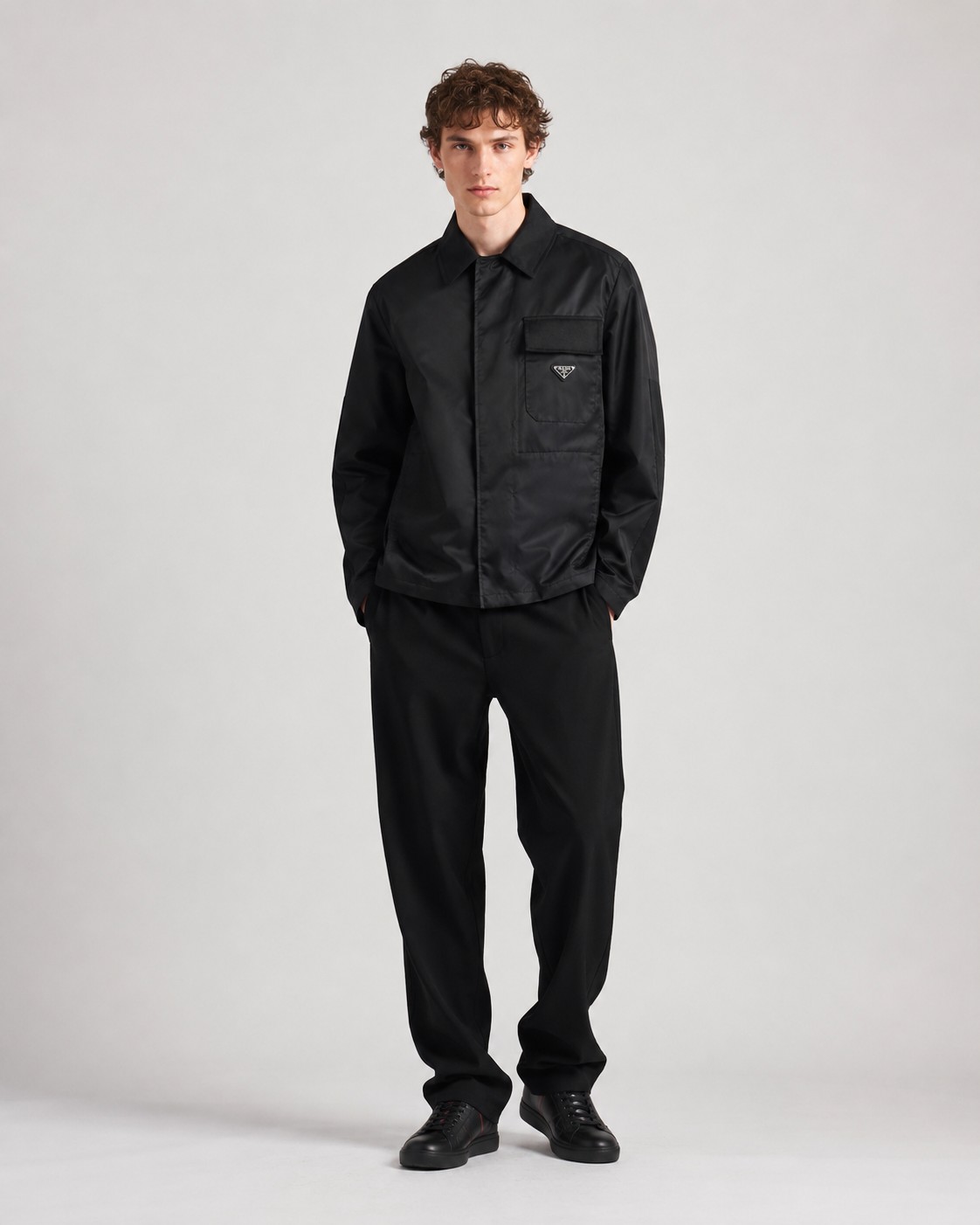 NO:938412,.[Button Version] PRA Regenerated Nylon Lapel Jacket Fabric Selection: The brand's iconic regenerated nylon fabric is used, which has the same performance as traditional nylon and has high strength, tear resistance, abrasion resistance and other properties. It is light in texture and has waterproof function suitable for multiple scene needs. It is anti-wrinkle and quick-drying and is easy to handle and maintain on a daily basis. Craftsmanship and details  The straight sleeves and dropped shoulders form smooth lines, and are paired with a straight hem design to highlight minimalism. The cotton twill shirt lapel contrasts with the regenerated nylon body. The softness of cotton balances the toughness and technology of nylon. The hidden snap closure makes it more aesthetic. There is a patch pocket on the left chest, with a twill plaid flap to highlight the sense of hierarchy.  , the enamel-coated triangle logo is decorated on the bag body to enhance visual recognition. The inseam pockets are integrated into the body with a hidden process, taking into account practicality and visual purity. The side pockets are reinforced at the beginning and end with pocket knotting technology to increase durability. The traditional lining is abandoned, and the stiffness of the fabric itself is used to shape the silhouette, reducing redundant layers while improving breathability.  Accessories one to one enamel triangle label One to one collar label SIZE: S M L XL,, prada, jackets & coats, shirts,19860909.【纽扣版】PRA再生尼龙翻领外套 面料选择 选用品牌标志性的再生尼龙面料,与传统尼龙性能相当,具备高强度,抗撕裂,耐磨损等特性.其质地轻盈,同时又具备防水功能适合多场景需求.抗皱,快干的特点也易于日常打理维护. 工艺与细节 直筒衣袖与落肩剪裁形成流畅线条,搭配平直底边设计,凸显极简主义.采用棉质斜纹布衬衫翻领与再生尼龙主体形成质感对比,棉质的柔软亲肤平衡了尼龙的硬朗科技感.隐藏式按扣开合使其更具美感.左胸口设有贴袋,搭配斜纹格布翻盖凸显层次感,将涂珐琅三角标饰以袋体之上,强化视觉辨识度.内接缝口袋以隐藏式工艺融入衣身,兼顾实用性和视觉纯净感.侧插袋口首尾均运用口袋套结工艺加固,增加耐用性.摒弃传统衬里,以面料本身的挺括度塑造廓形,减少冗余层次的同时提升透气性. 辅料一比一涂珐琅三角标 一比一领标 SIZE: S M L XL,,prada,jackets & coats,shirts,,Men's clothing