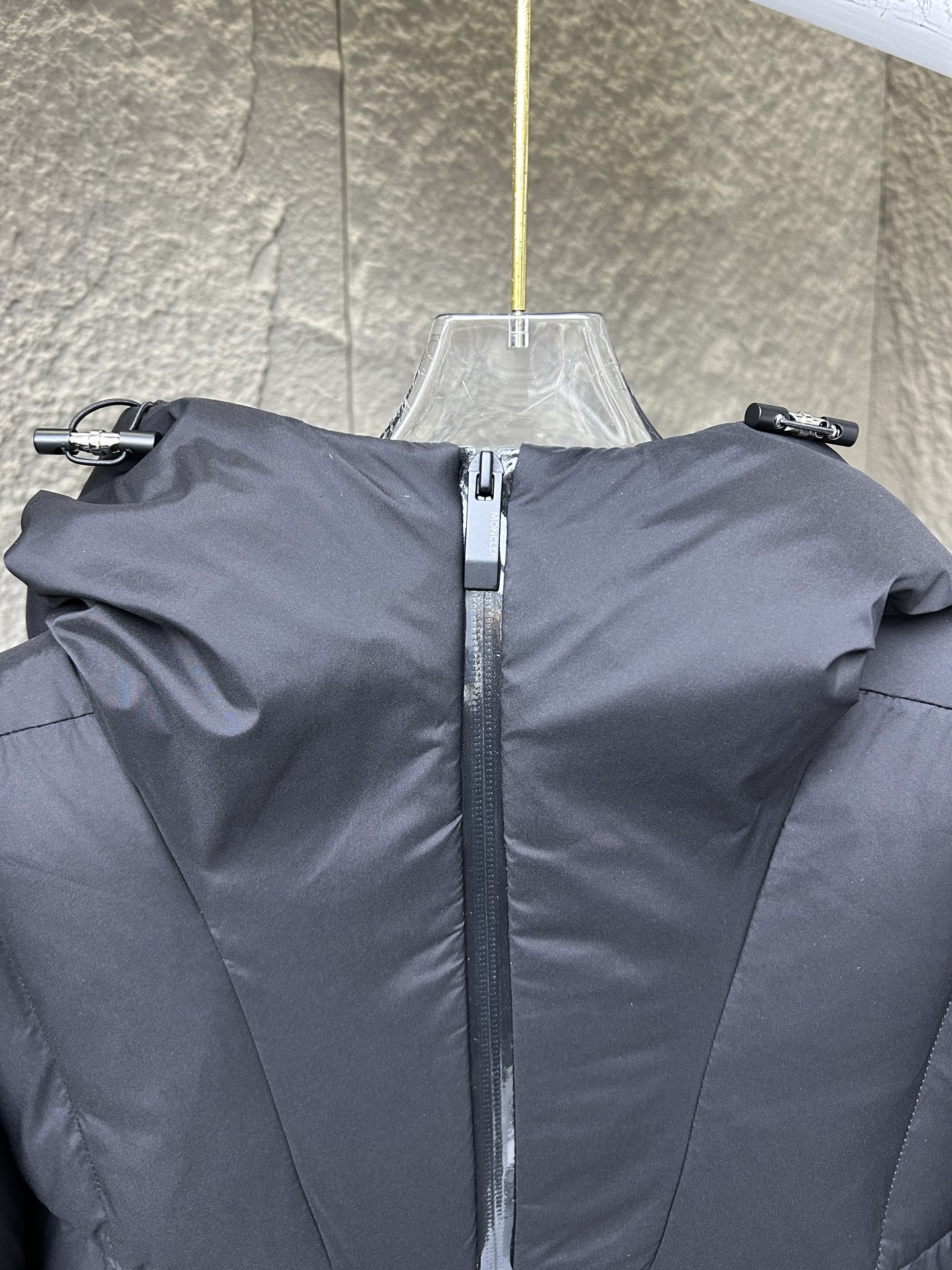 Moncler Fusain short down jacket inspired by racing. Features quilted nylon, lightweight warmth, sleek silhouette, hood, and reflective zipper. Available in black and off-white.-Big cat