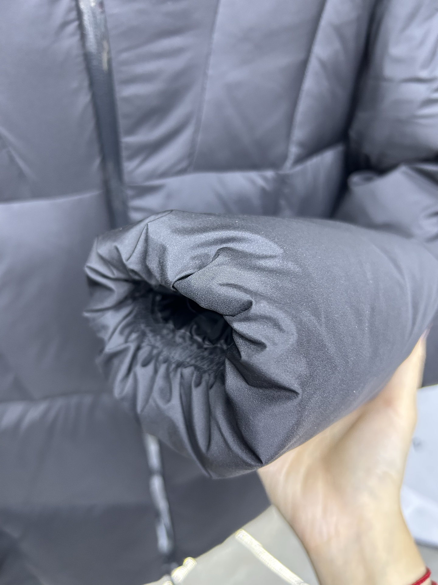 Moncler Fusain short down jacket inspired by racing. Features quilted nylon, lightweight warmth, sleek silhouette, hood, and reflective zipper. Available in black and off-white.-Big cat