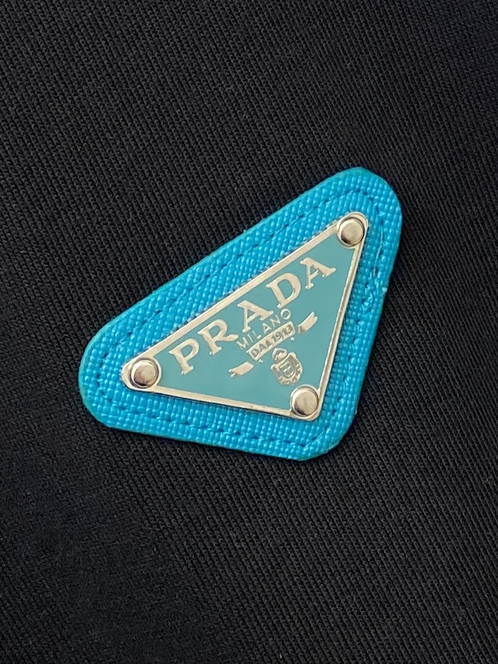 普拉达、2025新品短袖T恤，帅气时尚，简约百搭款。胸前五金装饰三角标logo，面料棉 不仅挺括，保持潮