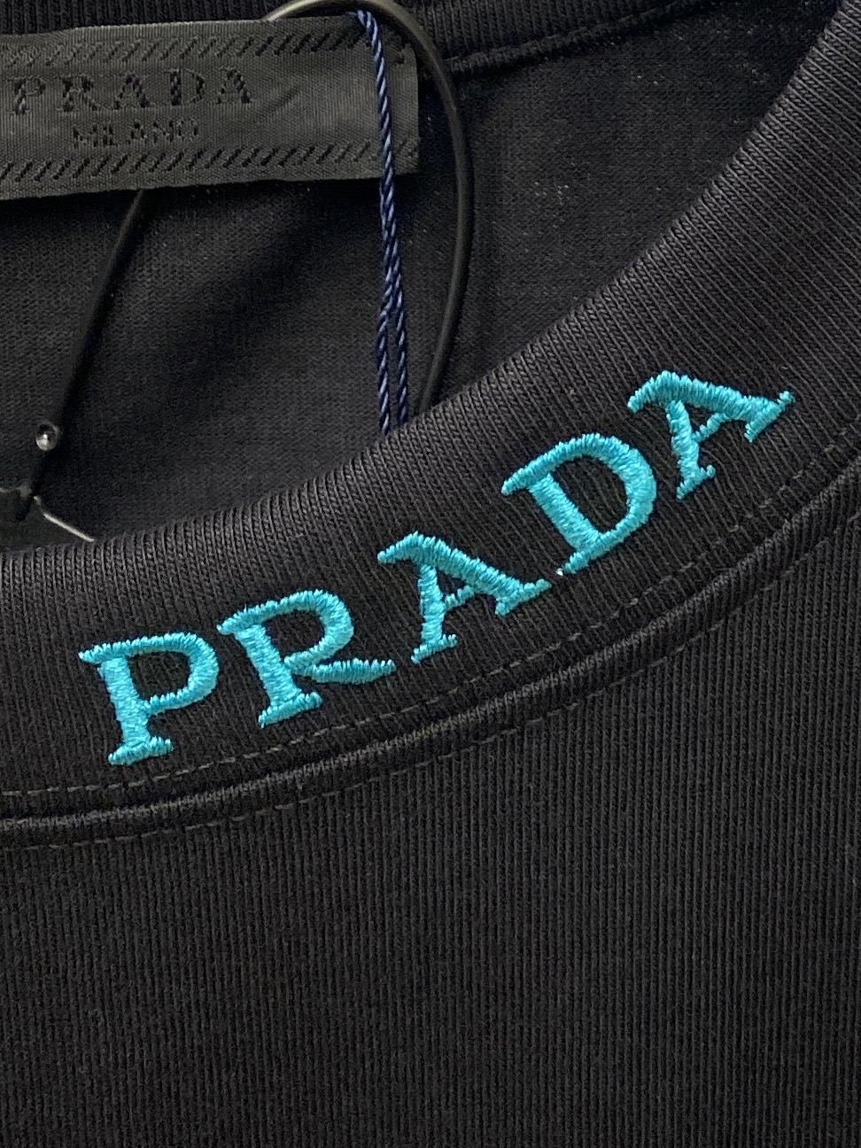 普拉达、2025新品短袖T恤，帅气时尚，简约百搭款。胸前五金装饰三角标logo，面料棉 不仅挺括，保持潮