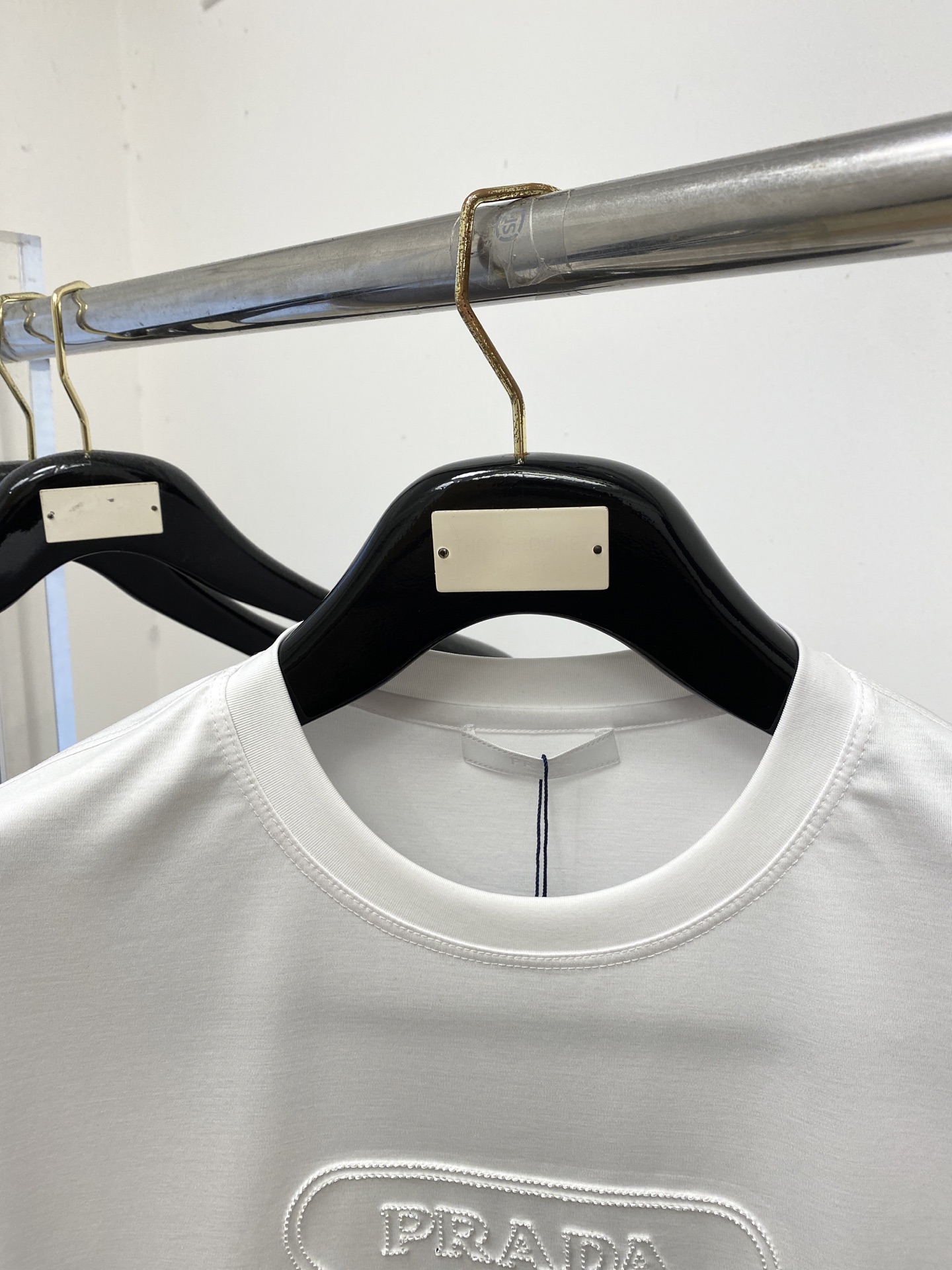 普拉达、2026新品短袖T恤，帅气时尚，简约百搭款。胸前精致刺绣五金装饰图案logo，面料棉 不仅挺括，