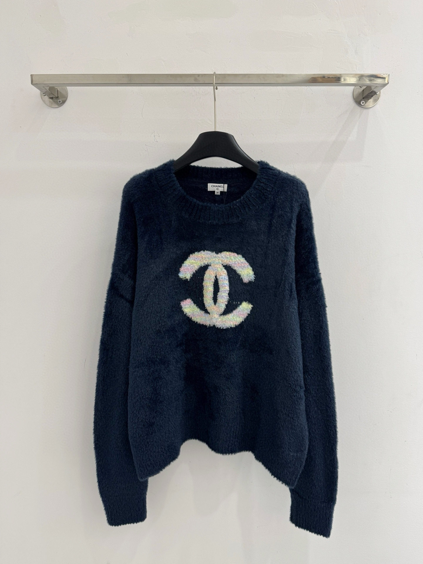 Chanel 深蓝色圆领毛衣‌慵懒风格 胸前彩色毛织刺绣双C标识 整体版型为落肩宽松设计 材质软糯针织面料