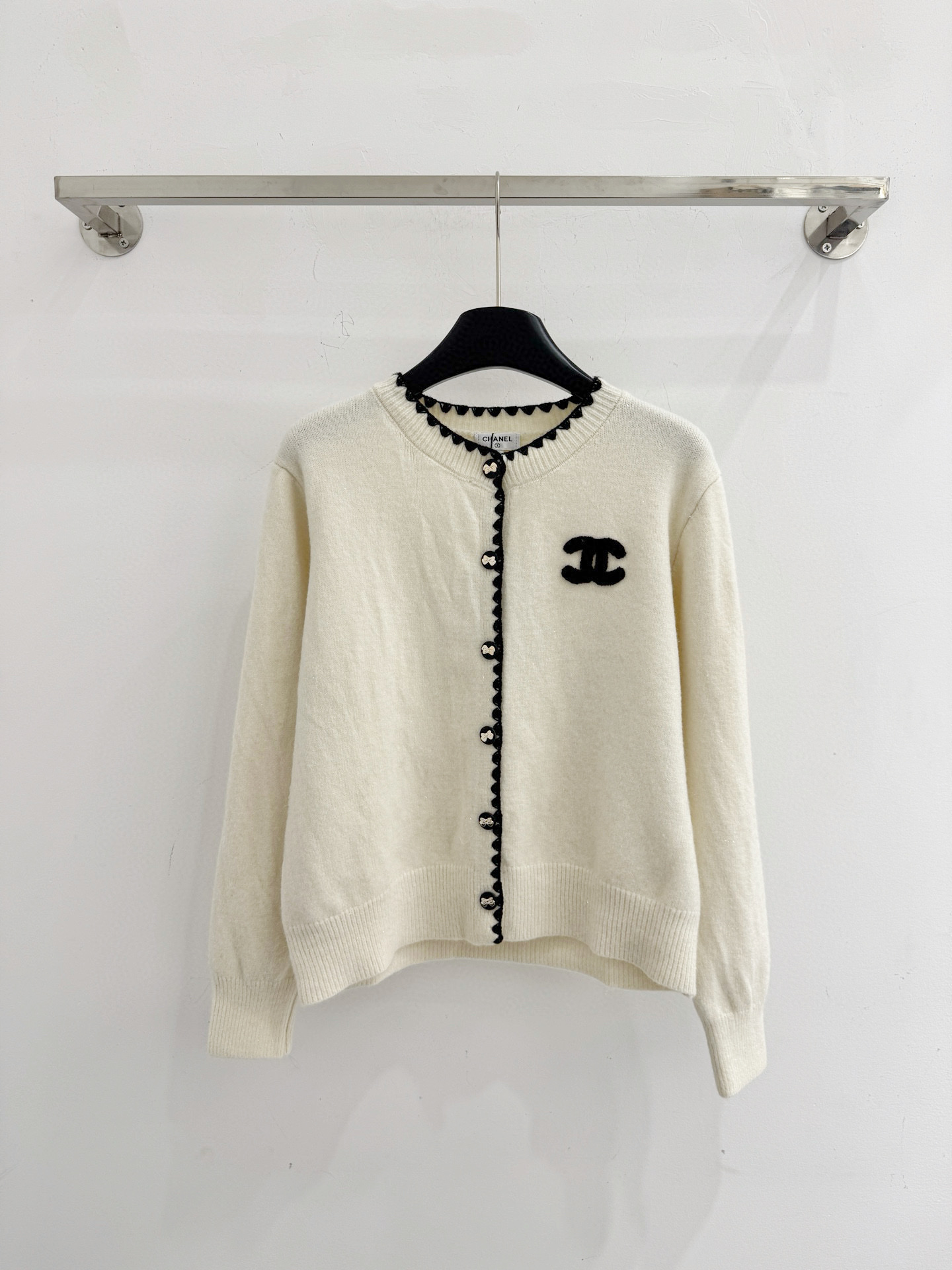 Chanel 圆领纽扣开衫‌设计，整体设计融合了品牌 元素与现代简约风格，纯色风格 简约百搭