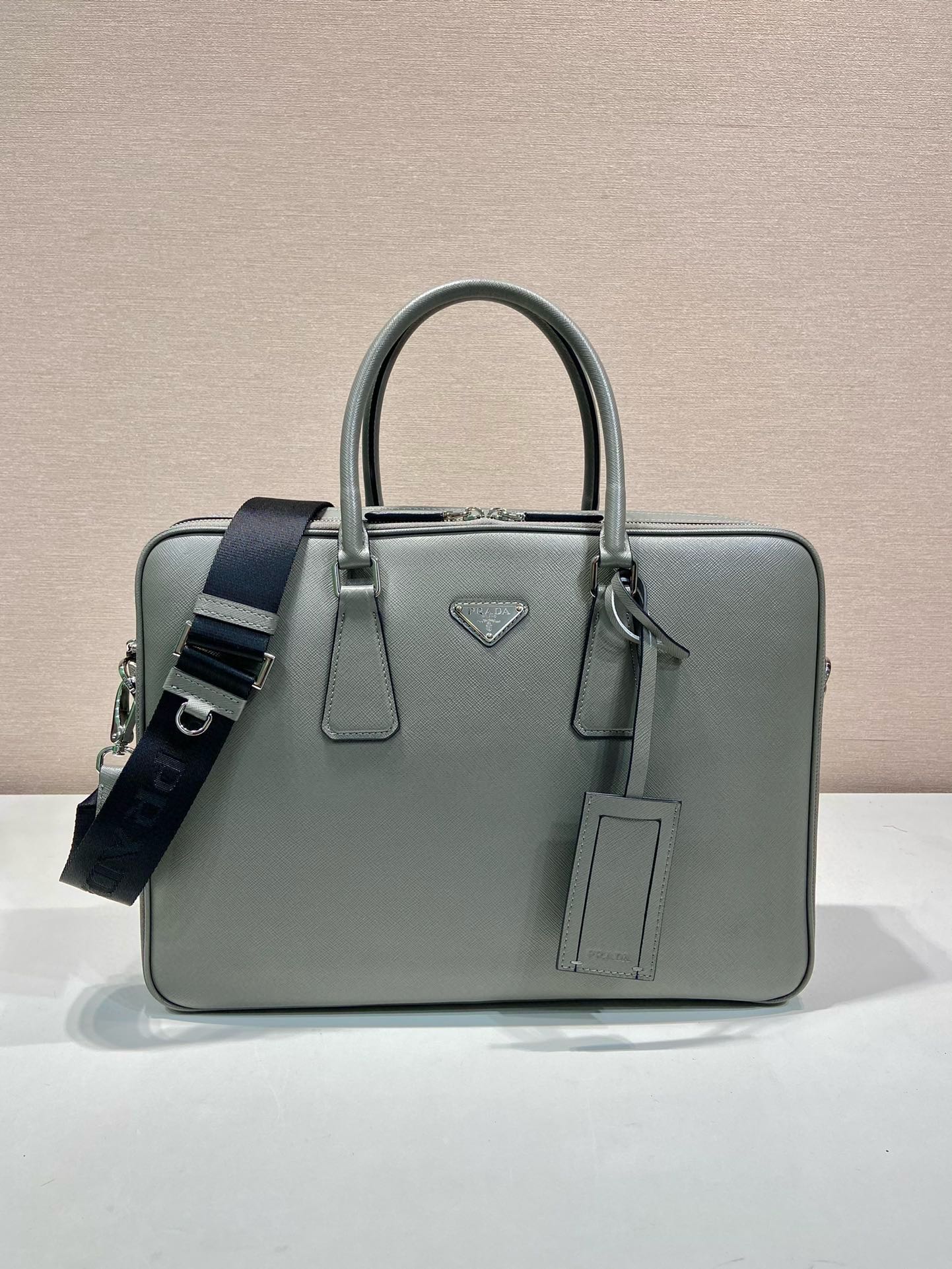 P Brand Double-Layer Briefcase 2VE022. This double-zip briefcase is made of imported top-grain cowhide, premium hardware, logo lining, and comes with a detachable adjustable fabric shoulder strap. It features multiple interior pockets, can fit a 14-inch laptop, making it the perfect item for daily commutes and business trips! Dimensions: 38 x 28 x 6.5 cm. Item number: 0071300. image 1
