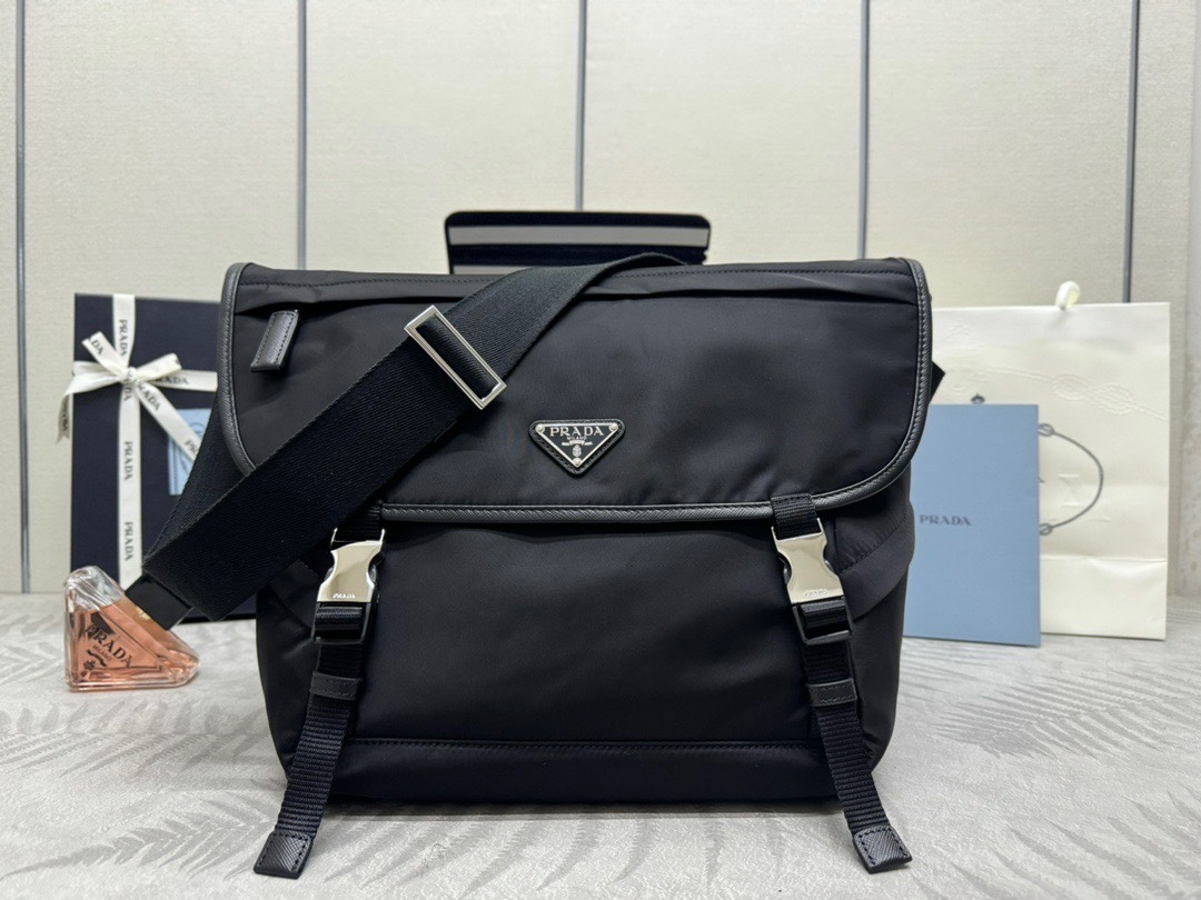P Family Large Messenger Bag 2VD052 Black. Made of recycled waterproof nylon fabric with premium hardware and adjustable fabric shoulder strap. Features flap with push-lock closure, three external zip pockets, internal zip pocket and slip pocket. Spacious, lightweight, and highly functional. Dimensions: 30 x 27.5 x 14.5 cm. 007780 image 1