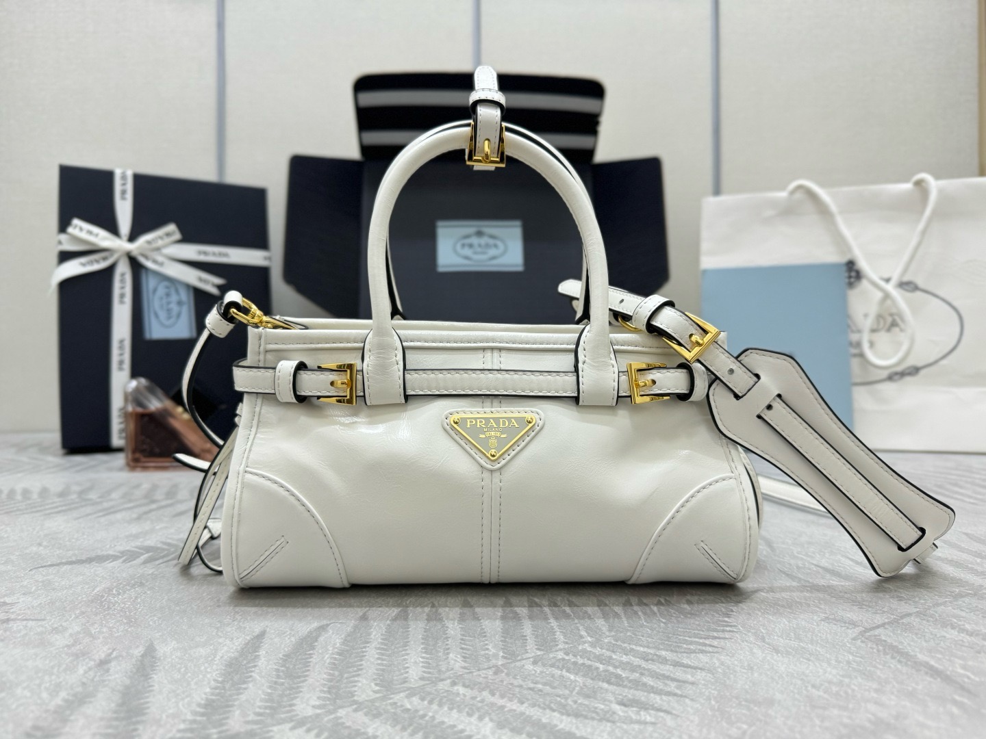 P Family Mini Tote Bag 1BA486. This mini Luxsoft handbag features imported first-layer waxed cowhide, logo lining, and premium hardware. Comes with a detachable adjustable long shoulder strap and zipper closure. Super lightweight, versatile, and adorable! Size: 23.5 x 12 x 9 cm. 007880 image 1