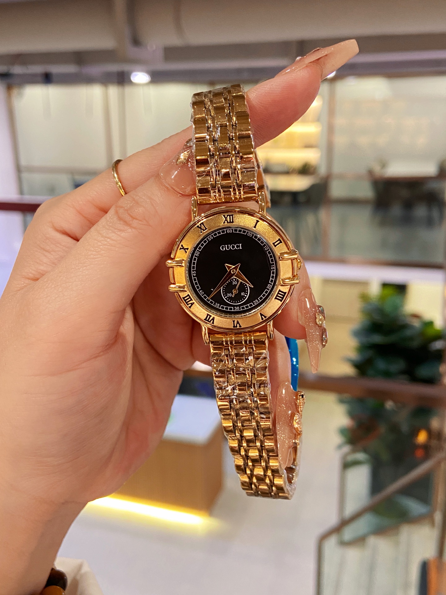 Gucci Women's Watch with Gold Stainless Steel Band and Black Dial