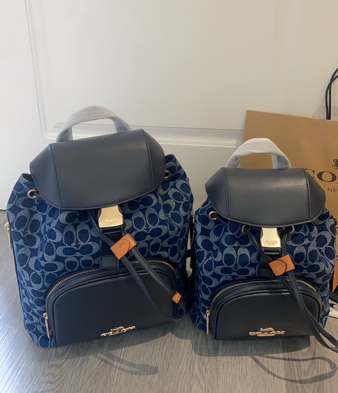 Coach's new May release, the CAS98 Pace denim backpack, features a combination of fabric and cowhide, offering a fantastic texture. The adjustable shoulder straps are thoughtful, and the external zipper, drawstring, and buckle closures make it convenient and practical. The large size measures 26/33 in height including the handle/8 in width. image 1
