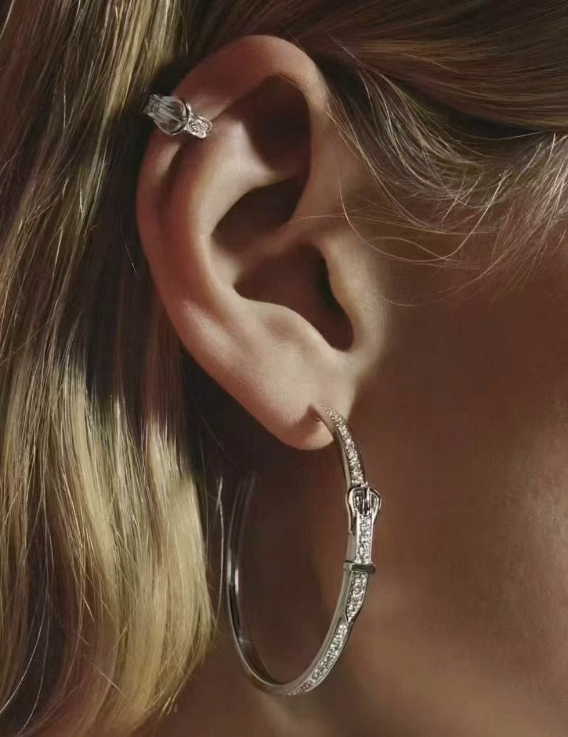 Hermes Buckle Hoop earrings Available in rose gold silver yellow gold metal tones with clear diamond-like accent stones 30mm diameter