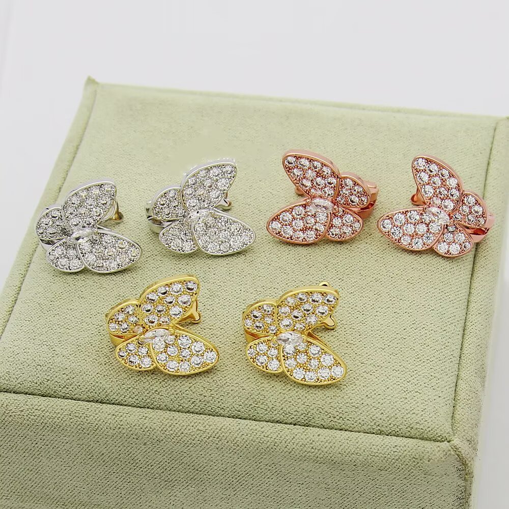 Van Cleef Arpels Boucles d'oreilles Two Butterfly Or jaune 18 carats avec diamants clairs Or blanc 18 carats avec diamants clairs Or rose 18 carats avec diamants clairs Taille unique