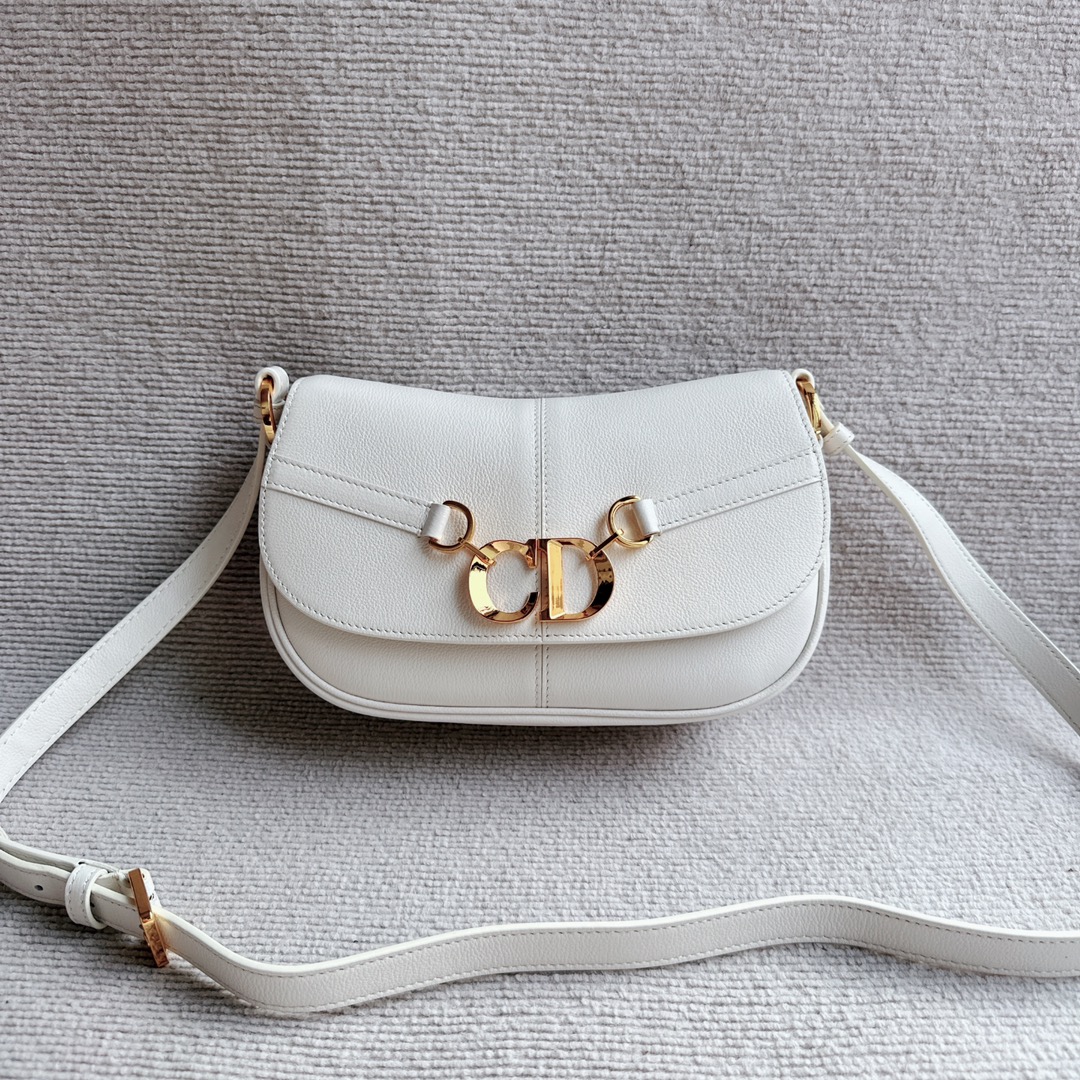 Dior CD Besace small all-leather saddle bag is carefully crafted from cowhide. The flap is decorated with an eye-catching vintage gold-finish met