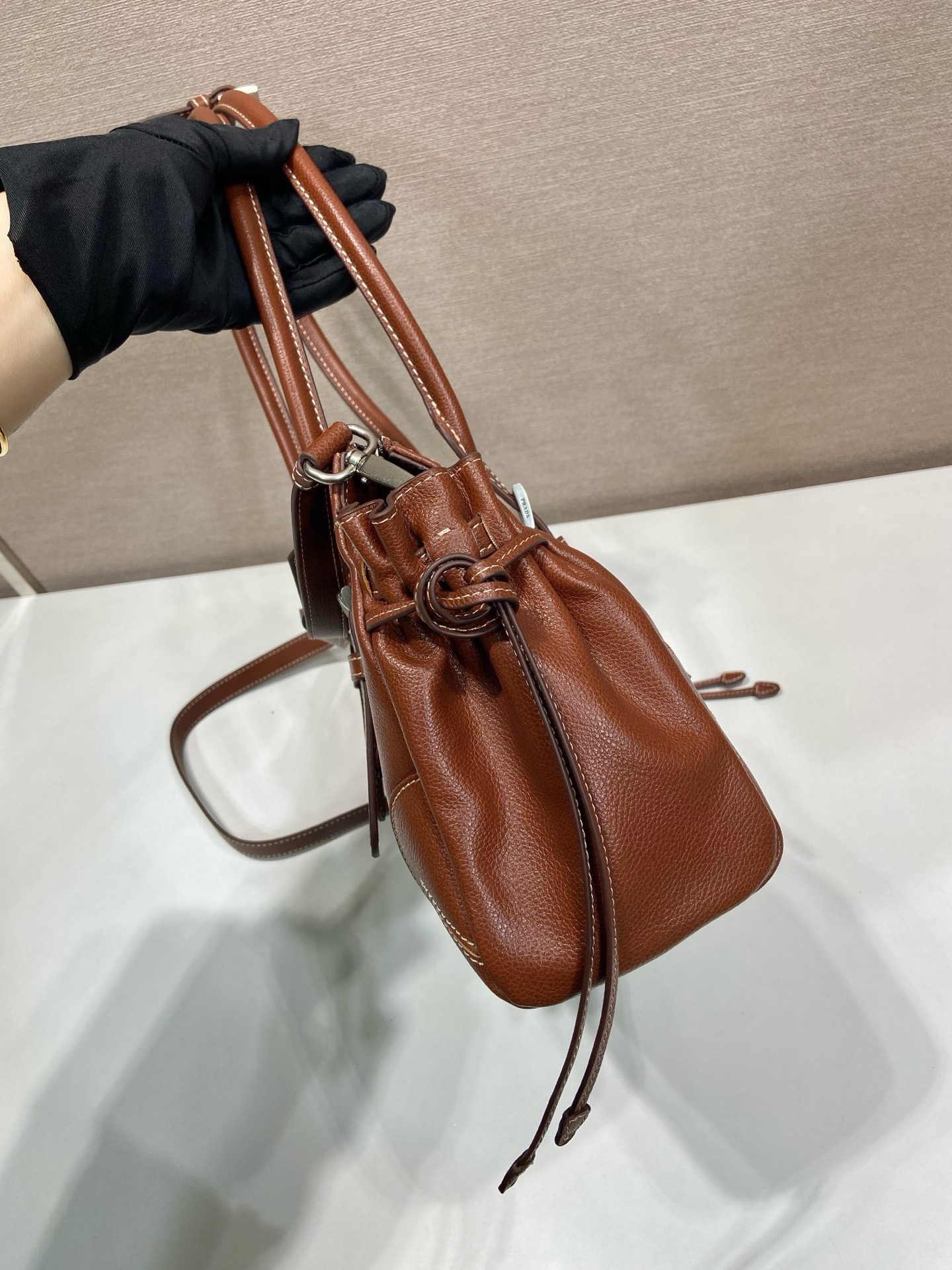 P820新款Bonnie1BG628
这款复古质感的皮包体现了精致而现代的个性。几何轮廓将现代、金属带扣和侧边鞋带设计。而长手柄则表明了一种务实和休闲的态度。配有一条可拆卸长肩带，方便不同场合搭配，容量空间非常大。
尺寸：32 x 17.5 x 10.5