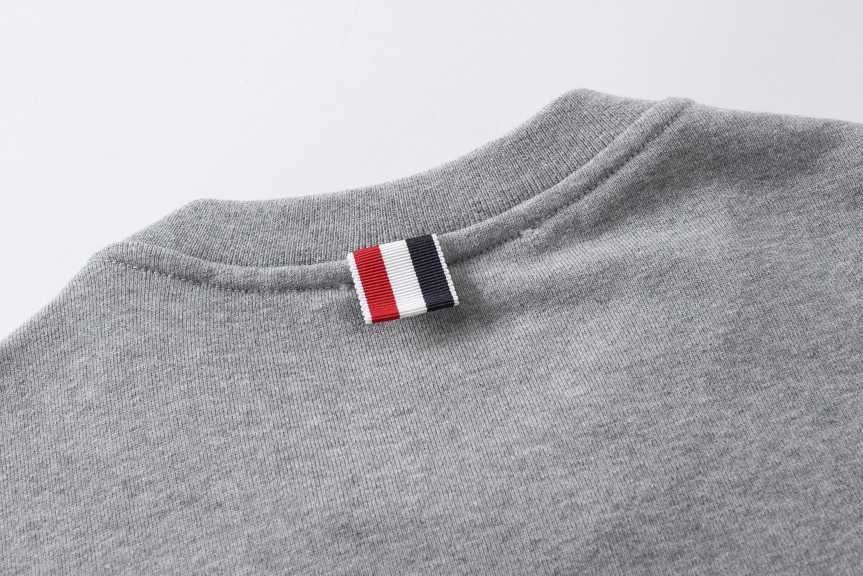 图片[6]-＃新春福利 THOM BROWNE 汤姆布朗. TB灰条蓝条色织四条杠卫衣 所有材料辅料均原版开模 成本1xx 清仓福利 高端私域跑量神器 TB卫衣经典色织灰、蓝彩条四条杠 ZP面料色织定制 380克重经典毛圈棉 高清还原细节 做工精细 采用进口缝纫设备缝制 针距细密 原版五金面料 细致到每一针线的完美细节做工 精良的裁剪设计 男女同款+专柜包装防尘袋 三标齐 顶级版 • 华夫格精梳棉基底：精选100%长绒棉，经过3次预缩处理，洗后不缩水、不起球，触感软糯却挺括有型，贴身穿也毫无束缚感。 • 四杠织带工艺：标志性的四杠条纹，并非简单印花，而是采用高密度提花织带，与衣身同色纱线交织，久穿不脱线、不褪色，每一道杠都是身份与质感的双重认证。 • 领口罗纹锁边：领口罗纹加入2%氨纶混纺，经过500次拉伸测试仍能回弹如初，搭配红白蓝织带包边，细节处尽显高级。 • 下摆按扣细节：下摆的金属按扣，采用哑光镀镍工艺，不刮衣、不生锈，开合顺滑，同时解决了卫衣下摆易上翻的尴尬。-选品中心
