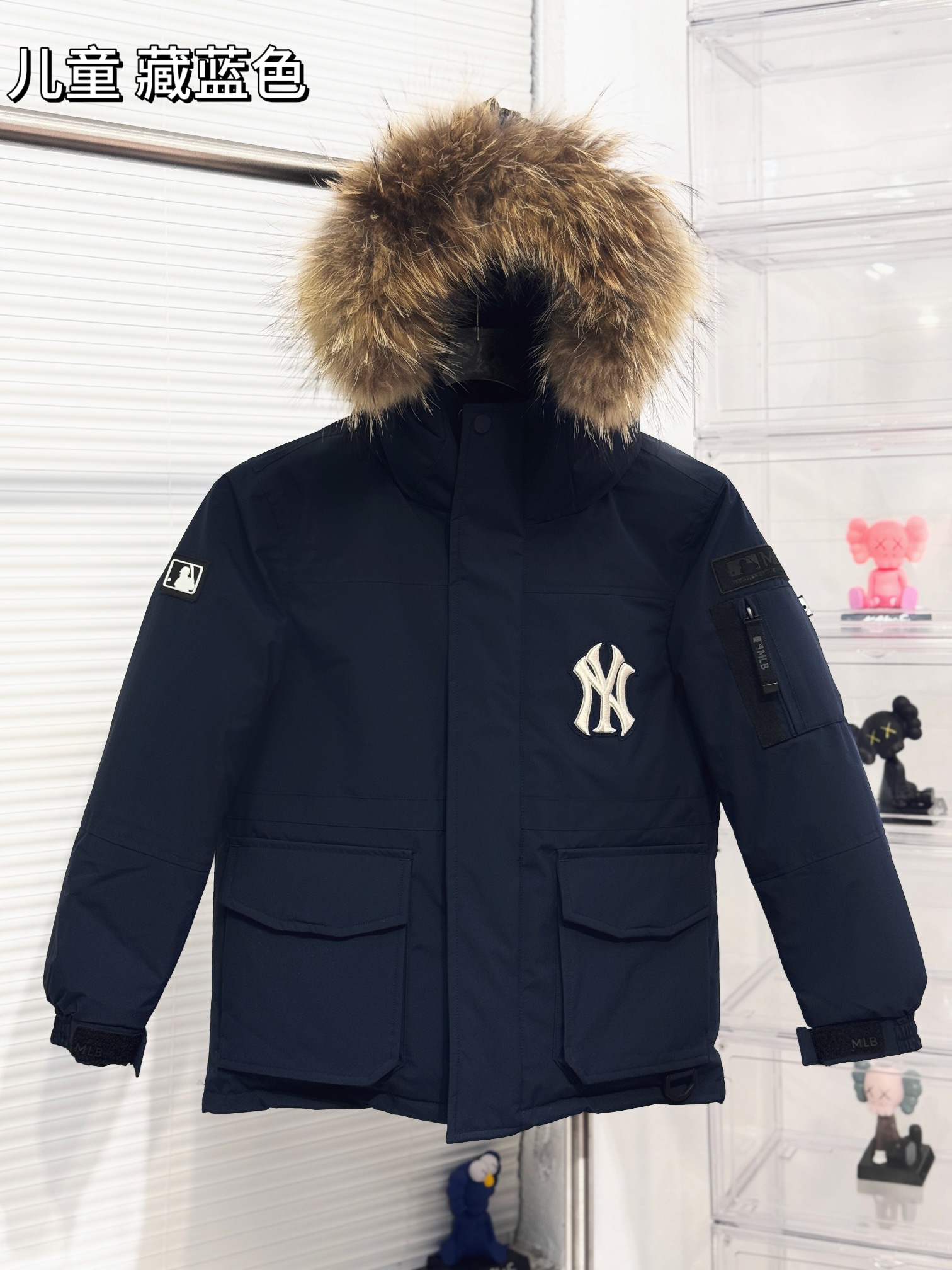 【儿童版出货实拍🎈 MLB洋基队24冬季新品大口袋工装毛领羽绒服® ▪️尺码：110－160 ▪️颜色：藏青 米白 军绿 黑色 粉色 填充物国标90白鸭绒，貉子毛真毛毛领，超级保暖。韩国一众明星拿来当团服的，必定是最好的!这款羽绒服运用了双层防绒内胆设计，防风性能超强，冬天穿会非常保暖!白鸭绒填充，蓬松度高，零下二十几度穿着也没问题~立领连帽设计走在户外把领子拉到最高，双手插进口袋非常暖和了~ 多功能机能风，多口袋工装系列经典款。防风袖口设计，领口带防绒拼接绒布，上身保护脖子不冰凉，穿上去超级暖和！国标90白鸭绒含绒量，平均280克 左右充绒量，蓬松度手感极佳，非常厚实。拉链原版定制拉logo链头，胸前经典刺绣小logo。商标吊牌➕水洗辅料 均按ZP一模一样。-选品中心