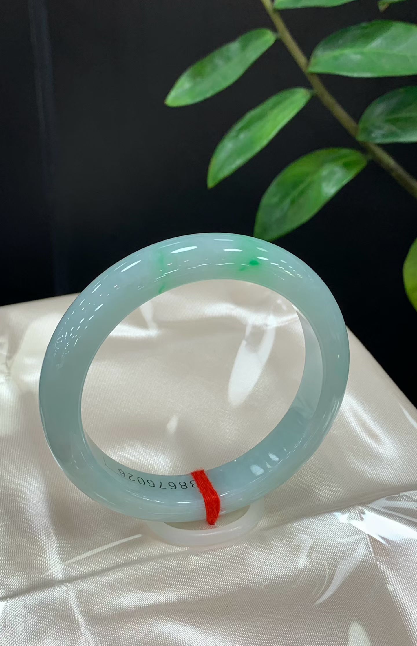 Positive round, clear base with floating green 3