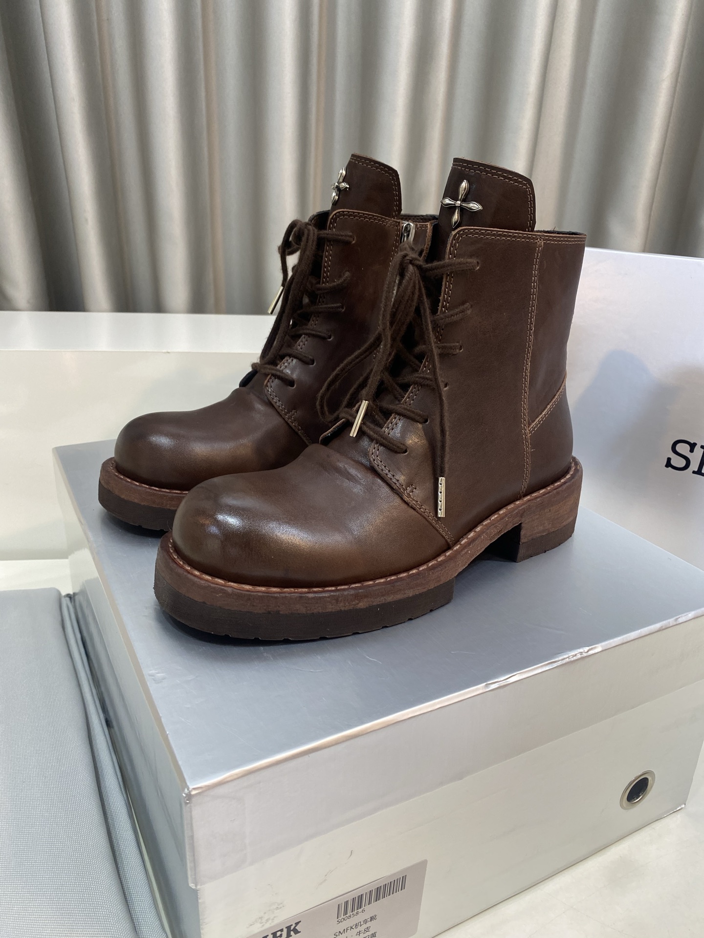 NO:614880,Smfk niche trendy brand 25ss popular new product retro lace-up Martin boots. This SMFK boot is based on classic retro colors and is full of retro charm. The rich leather is not only of high quality, but also versatile. Whether it is paired with casual jeans to show a casual and comfortable street style; or paired with a simple black dress to create a cool yet elegant temperament, it can be easily worn  .The boots adopt a dual design combining laces and zippers. The interlacing method of laces enriches the visual hierarchy and adds a casual and uninhibited feeling; the side zippers are easy to put on and take off, and also add a sense of modernity and neatness to the overall shape. In addition, the unique cross metal decoration on the tongue is highly recognizable, as if it is the brand's unique fashion imprint, injecting a mysterious and cool atmosphere into the entire pair of boots, instantly improving the fashion taste. The upper is made of original imported water-dyed cowhide.  The inner lining is water-dyed cowhide, the sole is original custom-made genuine leather water-dyed outsole, size 35-40 (custom-made 40 non-returnable), boots, boots, skirts, jeans, cowhide19860909Smfk 小众潮牌 25ss爆款新品 复古系带马丁靴 这款 SMFK 靴子以经典复古为主色调,复古韵味十足.浓郁的皮革不仅质感上乘,而且百搭性强,无论是搭配休闲的牛仔裤,展现随性自在的街头风；还是搭配简约的黑色连衣裙,营造酷帅又不失优雅的气质,都能轻松驾驭 .靴子采用了系带与拉链相结合的双重设计,鞋带的穿插系法丰富了视觉层次,增添了一份随性不羁的感觉；侧边拉链则方便穿脱,同时也为整体造型增添了现代感与利落感.此外,鞋舌处独特的十字金属装饰,极具辨识度,仿佛是品牌独特的时尚烙印,为整双靴子注入了神秘而酷感的气息,瞬间提升时尚品味. 鞋面采用原版进口水染牛皮 内里垫脚水染牛皮里 鞋底原版定制真皮水染大底 码数35-40（40定做不退换）,靴子,boots,skirts,jeans,cowhide,Women's Shoes